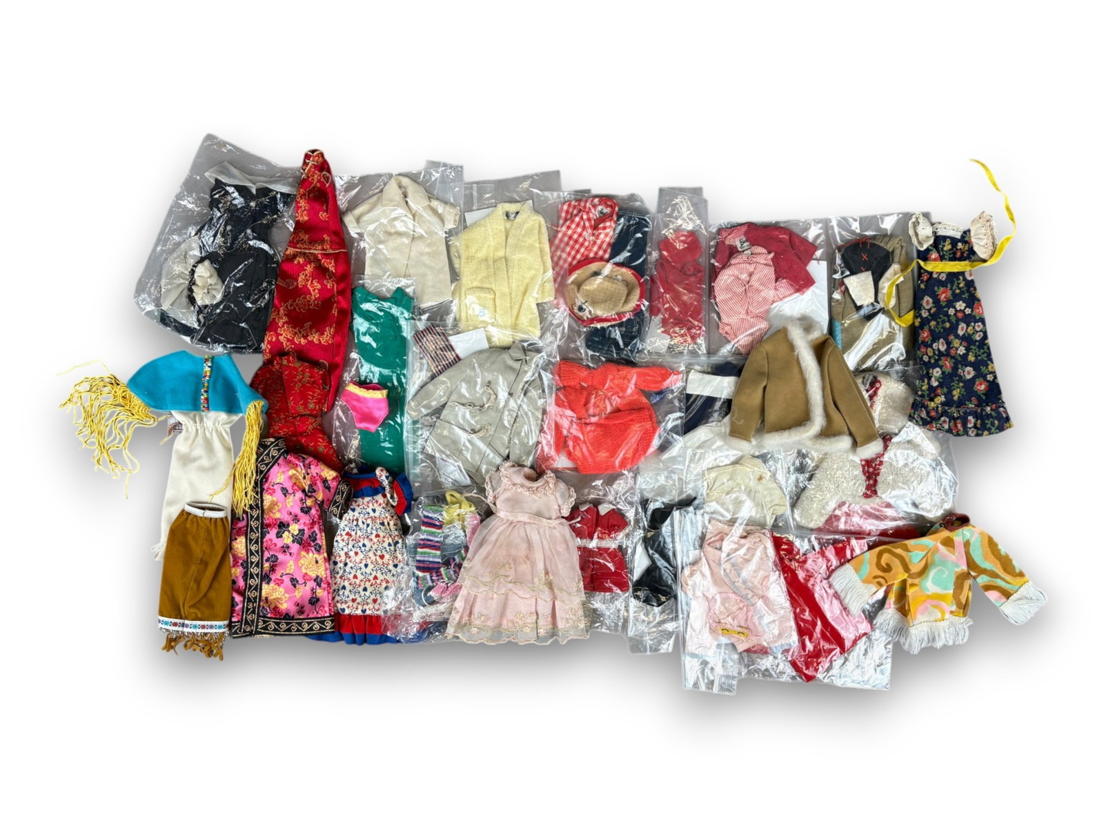 Vintage Barbie Clothes Box Lot: Box lot of Barbie and Ken clothing, some tagged. Circa 1960s. Shipping: Weiss Auctions offers full-service, in-house shipping for nearly all items in this auction. For a shipping quote, please contact