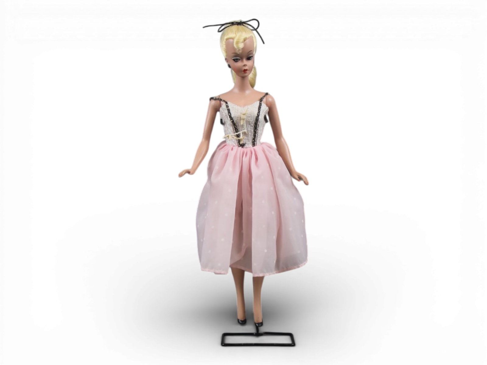 Original German Bild Lilli Doll, 11-1/2": German "Bild Lilli", 11-1/2" doll with molded and painted facial features, side-glancing eyes with molded lashes, high arched eyebrows, blonde inset wig styled in a ponytail with curl on her forehead,