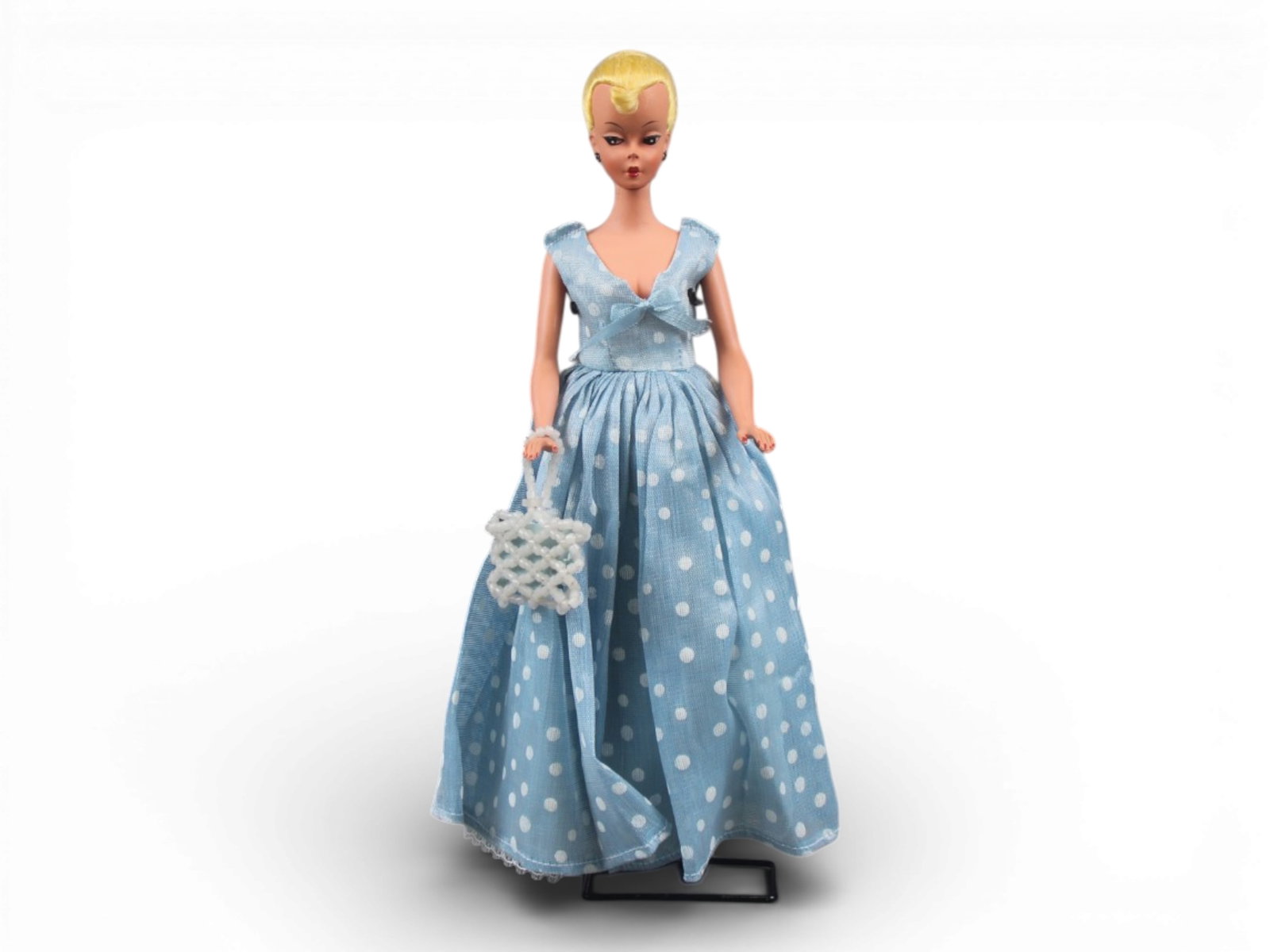 Original German Bild Lilli Doll, 11-1/2": German "Bild Lilli", 11-1/2" doll with molded and painted facial features, side-glancing eyes with molded lashes, high arched eyebrows, blonde inset wig styled in a ponytail with curl on her forehead,