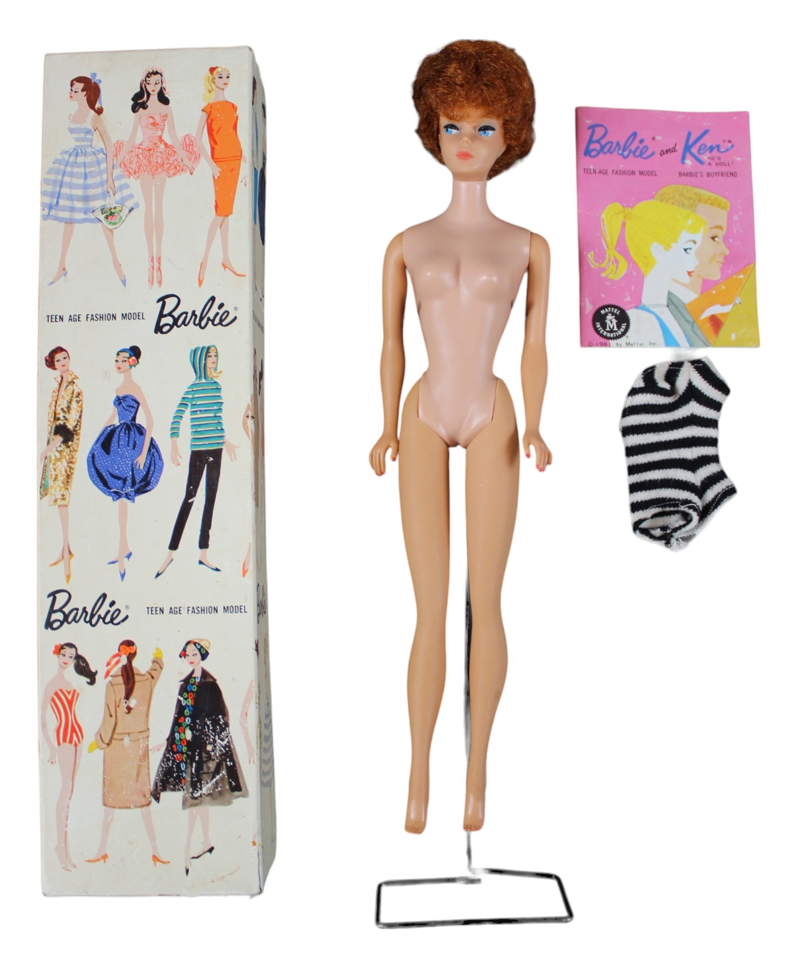 1961 Barbie #850 Titian Bubble Cut with Box: Titan bubble cut with original box, black and white zebra swimsuit, black open toe heels, pearl earrings, stand, and booklet. Clean doll. Original box has some edge/corner wear, and light surface wear