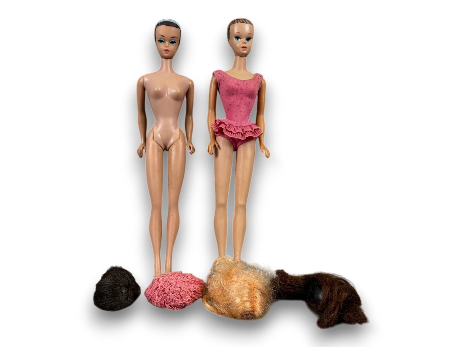 (2) Barbie Dolls with Accessories: Fashion Queen and Miss Barbie with wigs and accessories. Circa 1963-1964. Shipping: Weiss Auctions offers full-service, in-house shipping for nearly all items in this auction. For a shipping quote, pl