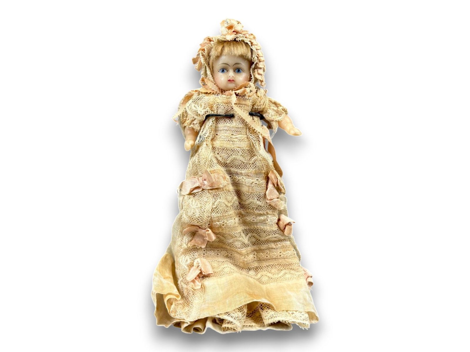 Poured Wax Baby Doll: 6.5 inch poured wax baby with christening outfit. Circa 1850. Shipping: Weiss Auctions offers full-service, in-house shipping for nearly all items in this auction. For a shipping quote, please contact