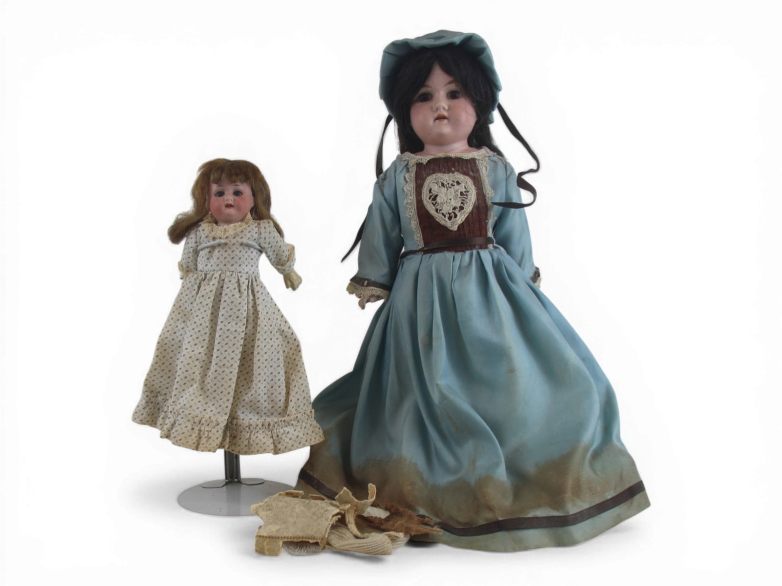 (2) German Bisque Head Dolls: 18 inch Floridora Armand Marseille bisque shoulder head doll with hairline and needing attention. Also a 9.5 inch Heubach Koppelsdorf bisque head doll on five piece composition body. Both circa 1900. 