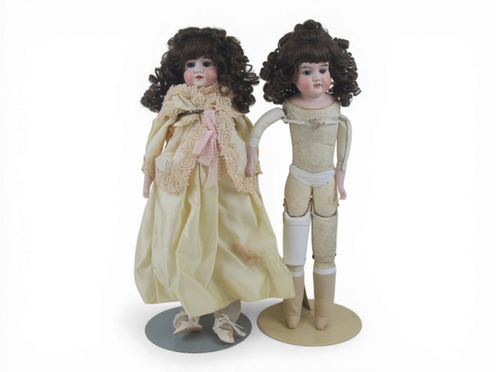 (2) Majestic Bisque Shoulder Dolls: Two Majestic bisque shoulder head dolls measuring 21 and 23 inches on kidskin bodies with replaced arms. Both offered as is. Circa 1890. Shipping: Weiss Auctions offers full-service, in-house shipping