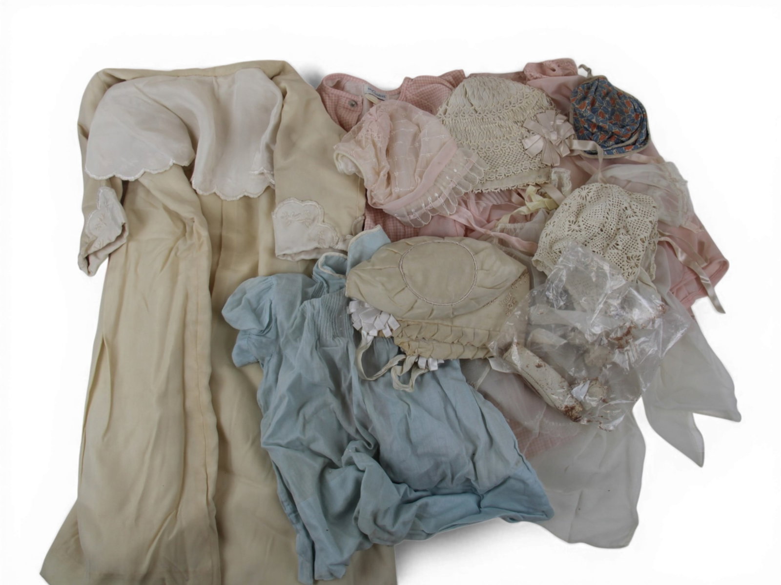 (9) Vintage Doll Clothing Pieces: Group of vintage doll clothing including four bonnets and five dresses. Circa 1900-1950. Shipping: Weiss Auctions offers full-service, in-house shipping for nearly all items in this auction. For a