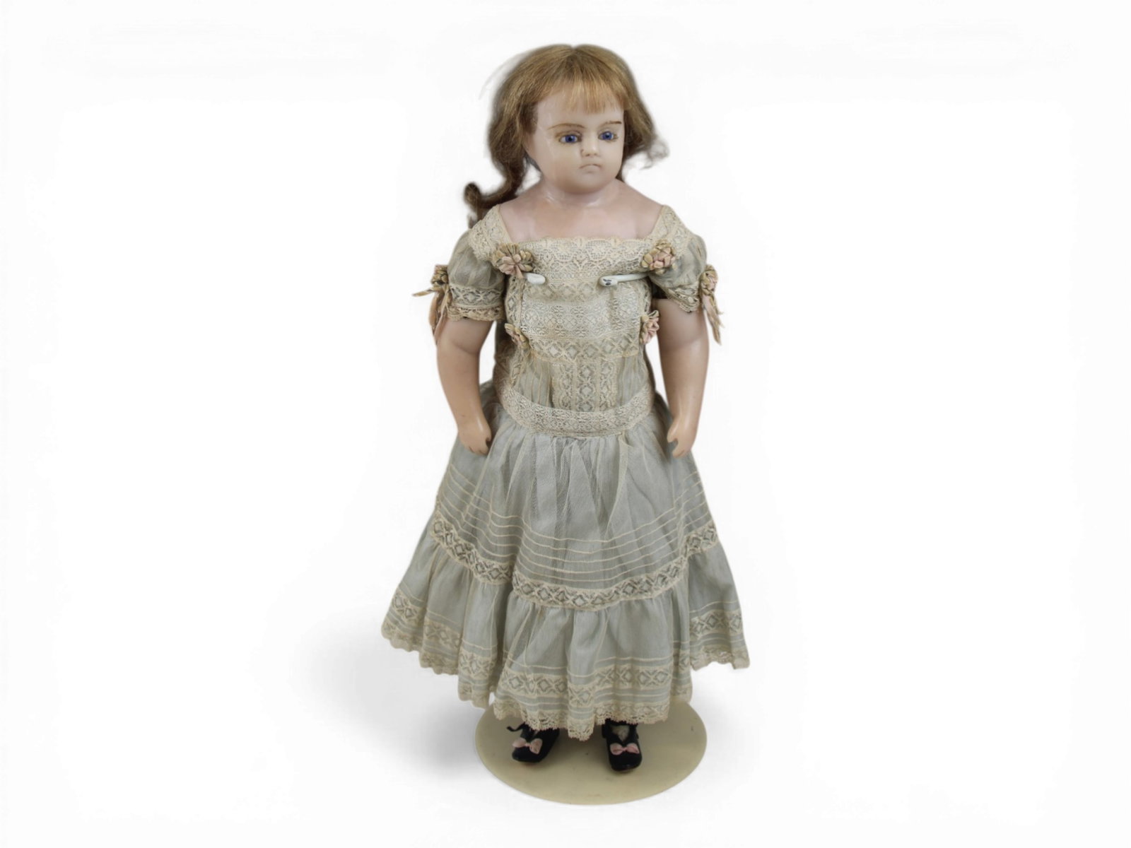 English Poured Wax Antique Doll: 22.5 inch English poured wax doll with cloth body and wax extremities. Repairs to sides of face. Circa 1870. Shipping: Weiss Auctions offers full-service, in-house shipping for nearly all items in thi