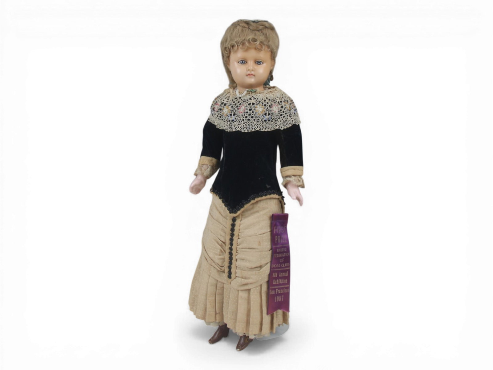 English Poured Wax Antique Doll: 20 inch English poured wax doll with cloth body and wax extremities. Original costume and prize award. Crack on side of face. Circa 1870. Shipping: Weiss Auctions offers full-service, in-house shippin