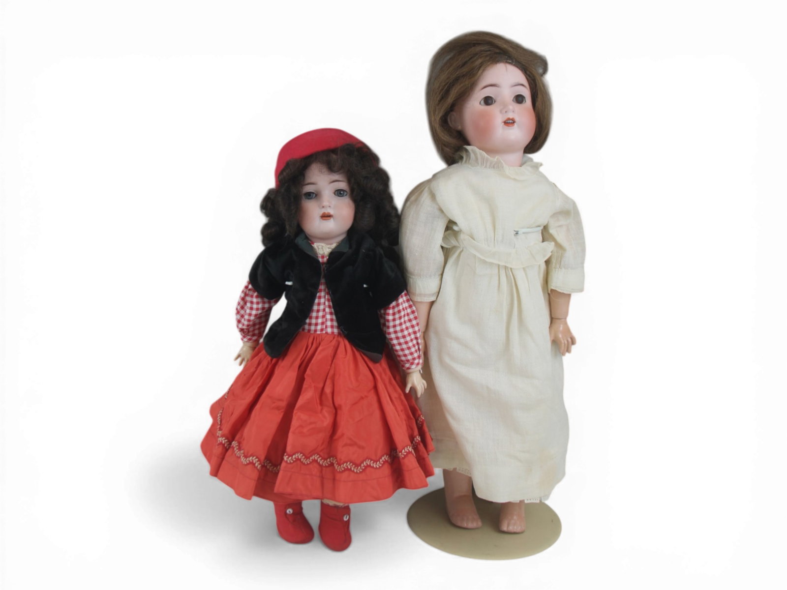 (2) German Bisque Head Dolls: Two German bisque socket head dolls measuring 19 and 24 inches, both on fully jointed composition bodies, with dresses. Circa 1910. Shipping: Weiss Auctions offers full-service, in-house shipping for 