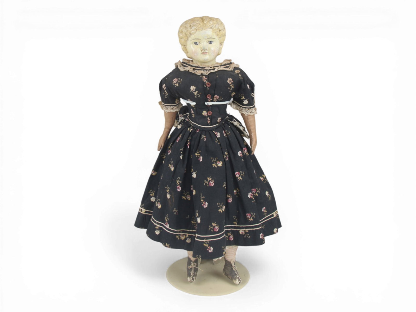German Papier Mache Antique Doll: 22 inch German papier mache doll on cloth body with leather arms and antique dress. Circa 1860s. Shipping: Weiss Auctions offers full-service, in-house shipping for nearly all items in this auction. F