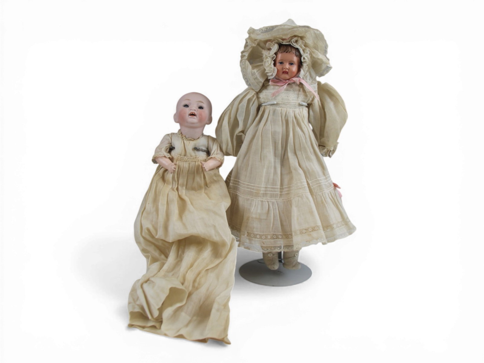 (2) German Baby Dolls: 13 inch celluloid shoulder head on oilcloth body with bisque hands, all original, and a 9 inch bisque socket head baby on bent limb composition body. Circa 1900 and 1920s. Shipping: Weiss Auctions off