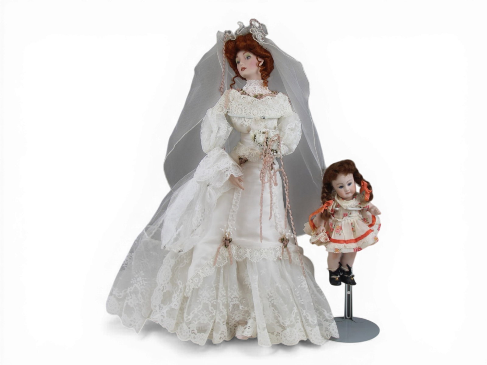 (2) Modern Bisque Dolls: 22 inch Gibson Girl bride doll and an 8.5 inch reproduction all bisque doll. Circa 1980s and 1990s. Shipping: Weiss Auctions offers full-service, in-house shipping for nearly all items in this auction