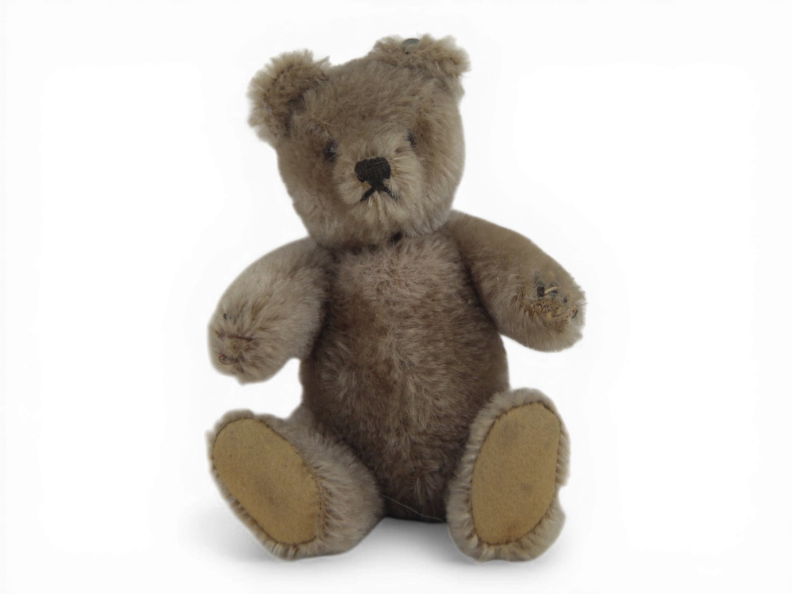 Small Steiff Mohair Teddy Bear: 7 inch tan mohair jointed teddy bear with glass eyes and early pewter button. Shipping: Weiss Auctions offers full-service, in-house shipping for nearly all items in this auction. For a shipping