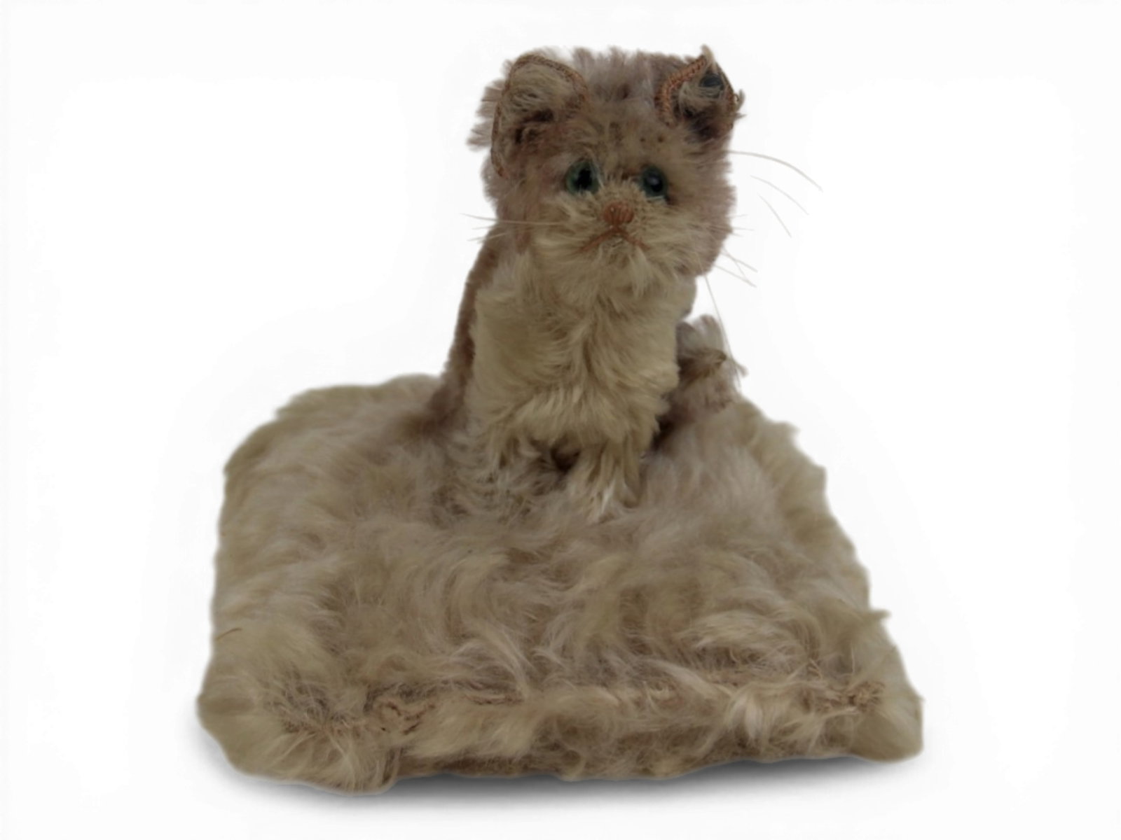Steiff Cat on Pillow: Steiff cat on pillow with 6 inch square pillow and 5 inch tall mohair cat, glass eyes, and early tin button marked Steiff in script with long trailing F. Circa 1906-1930s. Rare. Shipping: Weiss