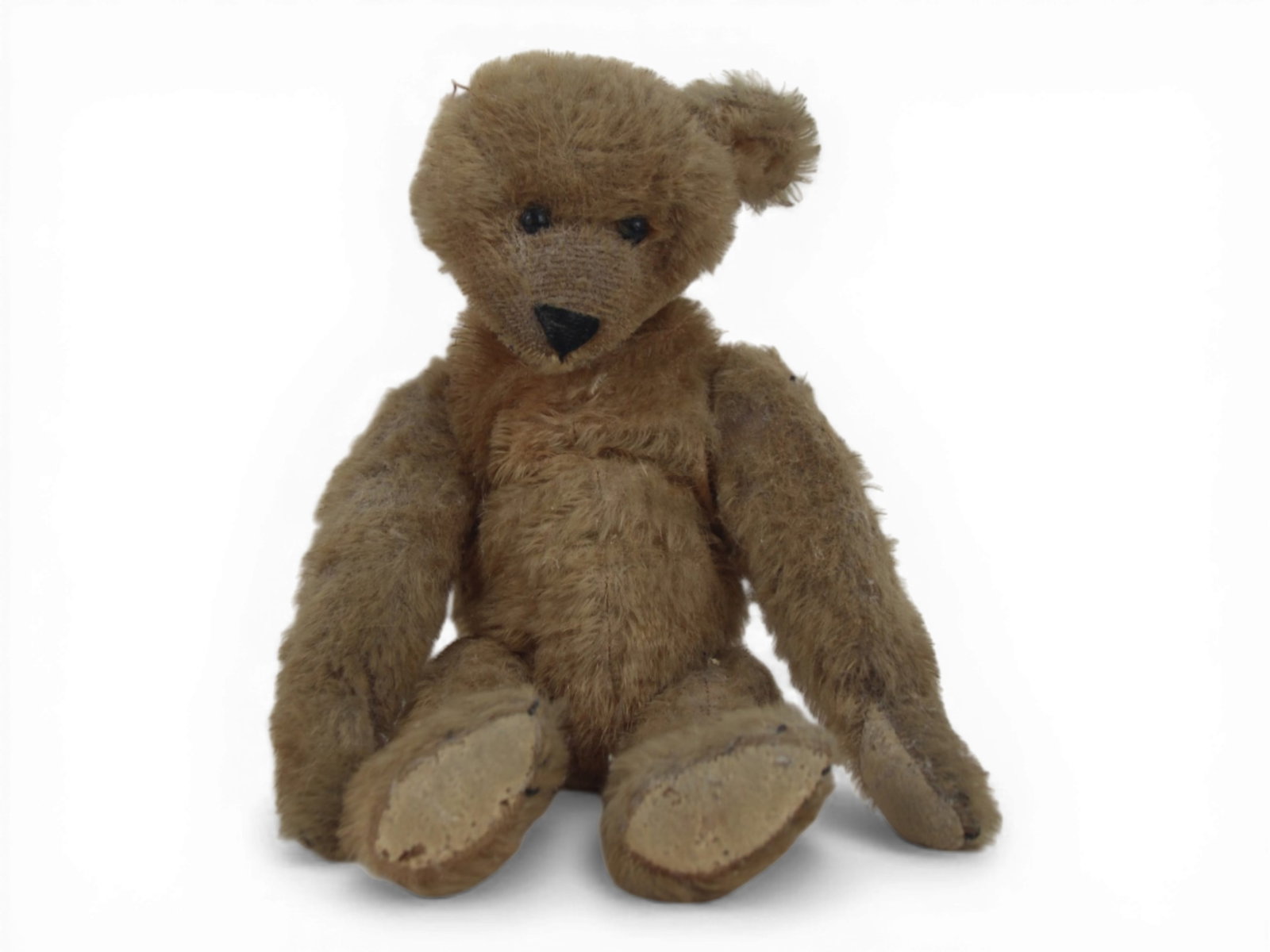 Bing Attributed Mohair Bear: 12.5 inch tan mohair bear with jointed limbs and shoe button eyes. Missing an ear with some missing embroidery. Circa 1910. Shipping: Weiss Auctions offers full-service, in-house shipping for nearly a