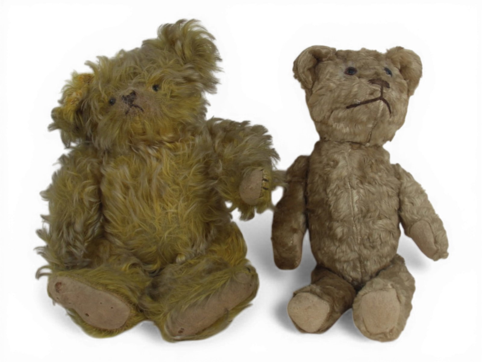 (2) Mohair and Plush Teddy Bears: Two vintage bears including a 14 inch silk plush bear with jointed limbs and glass eyes and a 12 inch shaggy golden mohair bear with jointed limbs and glass eyes. Ear needs to be reattached. Circa 191