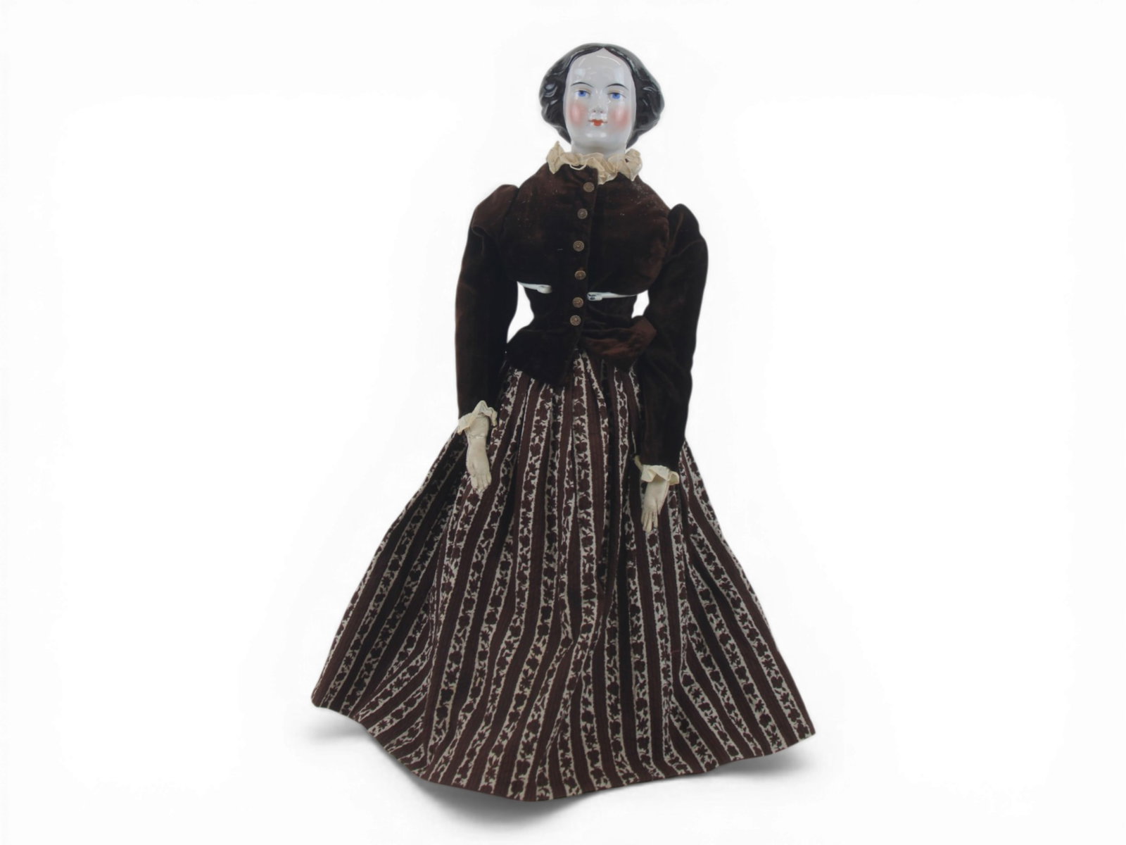 Jenny Lind China Head Doll: 23.5 inch china shoulder head with molded bun and painted eyes on cloth body with kidskin arms and cloth feet. Costume and extra skirt included. Circa 1870. Shipping: Weiss Auctions offers full-servic