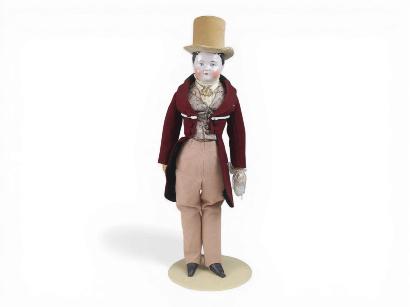 Pink Tinted China Head Gentleman Doll: 21 inch pink tinted china shoulder head gentleman with molded hair and painted eyes on cloth body with kidskin arms, in labeled Regency style costume. Circa 1840. Shipping: Weiss Auctions offers full-