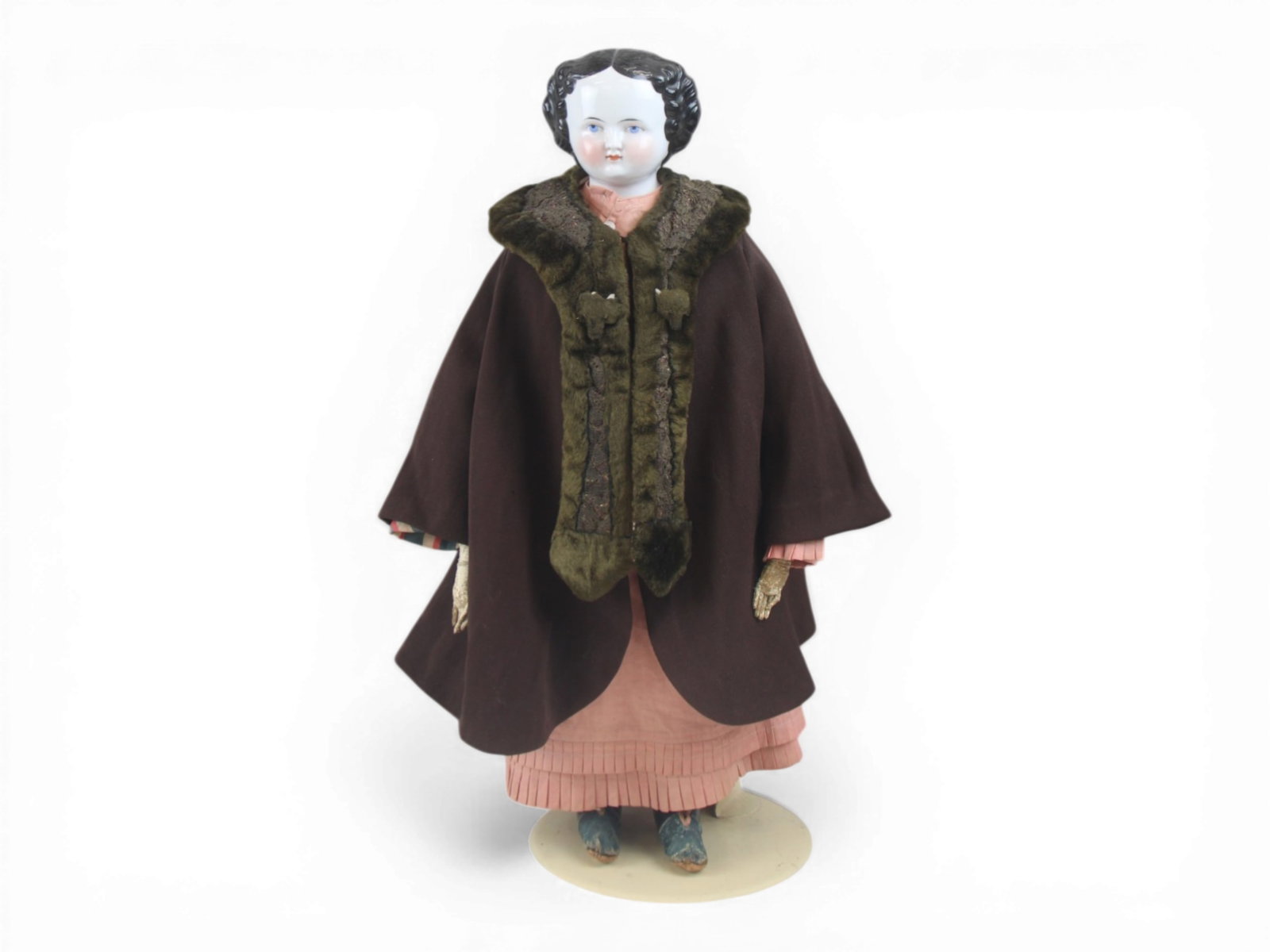 China Head Lady Doll in Original Costume: 22 inch china shoulder head lady with molded hair and painted eyes on cloth body with kidskin arms, original costume and shoes. Covered Wagon hairstyle. Circa 1870s. Shipping: Weiss Auctions offers fu