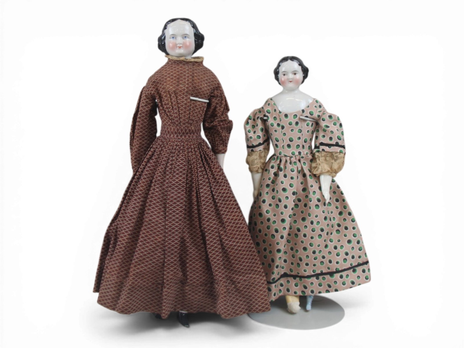 (2) China Head Lady Dolls: Two china head ladies including an 18 inch doll with china limbs and eight broken fingers, plus a 15.5 inch doll with replaced cloth body and replaced porcelain arms and legs. Covered Wagon hairstyle.
