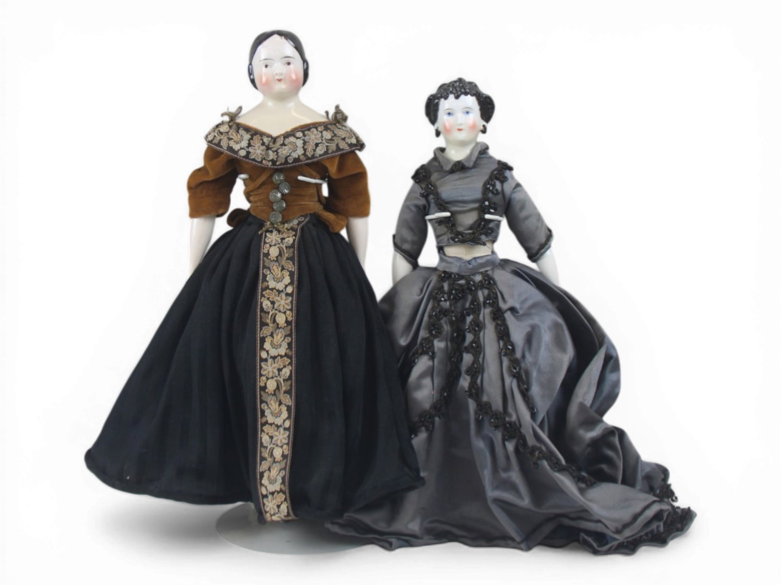 (2) China Head Lady Dolls: Two china head ladies including a 17 inch Covered Wagon hairstyle doll with restoration to neck and shoulder plate, plus a 15.5 inch Dagmar china shoulder head with repair to neck. Both circa 1880s. S