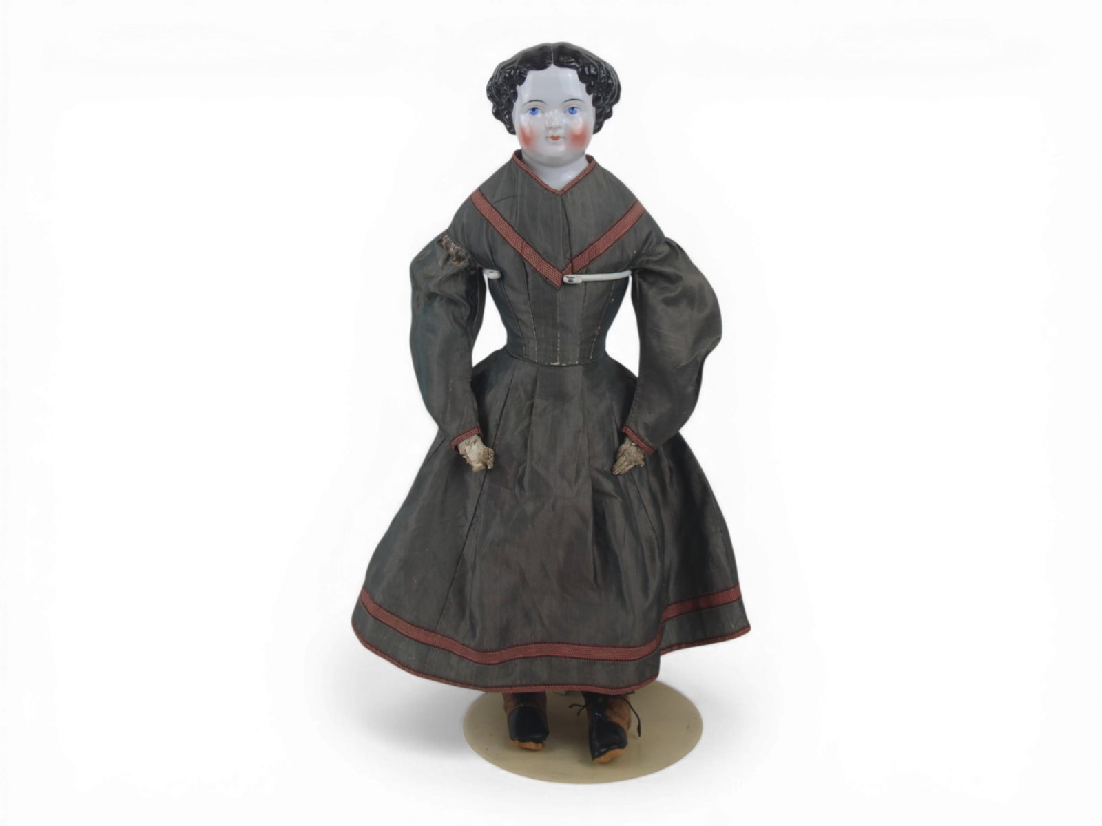 China Head Lady Doll with Shoes: 21 inch china shoulder head with molded painted hairstyle and painted eyes on cloth body with kidskin arms, original costume and shoes. Circa 1880s. Shipping: Weiss Auctions offers full-service, in-ho