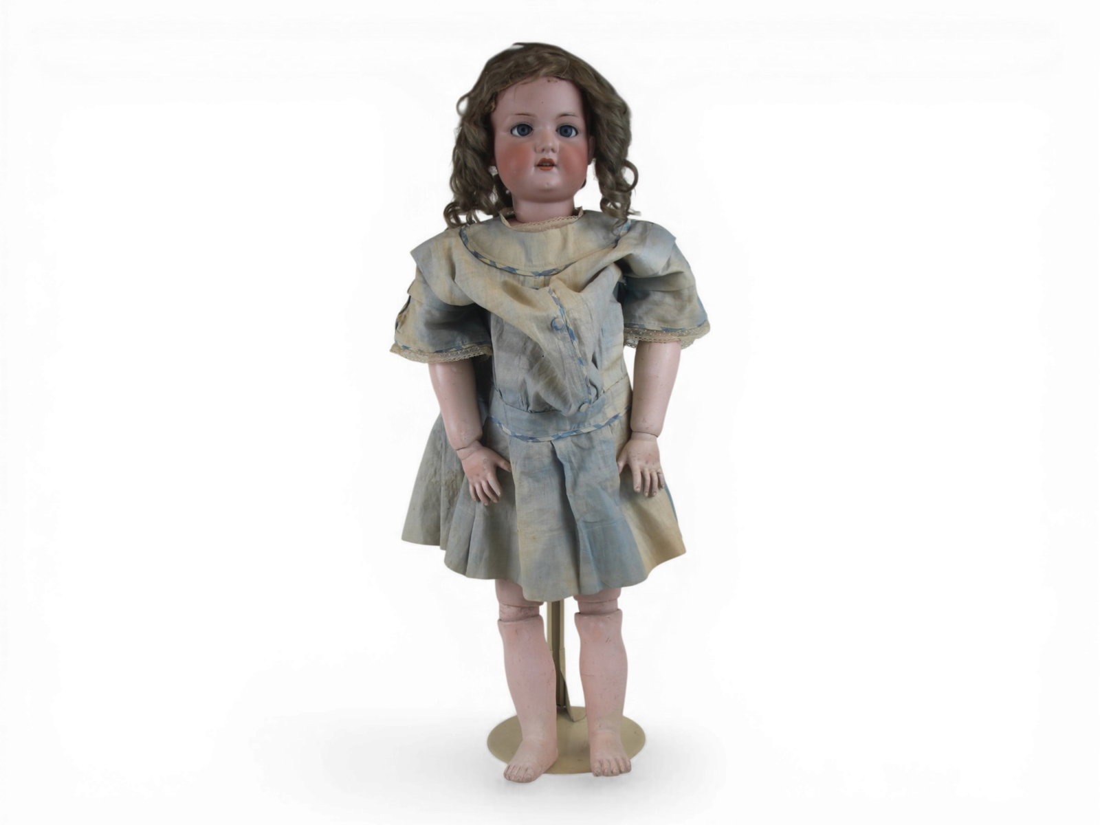 Armand Marseille Large Bisque Doll: 32 inch bisque socket head on fully jointed composition and wood body with antique dress with fading. Shipping: Weiss Auctions offers full-service, in-house shipping for nearly all items in this aucti