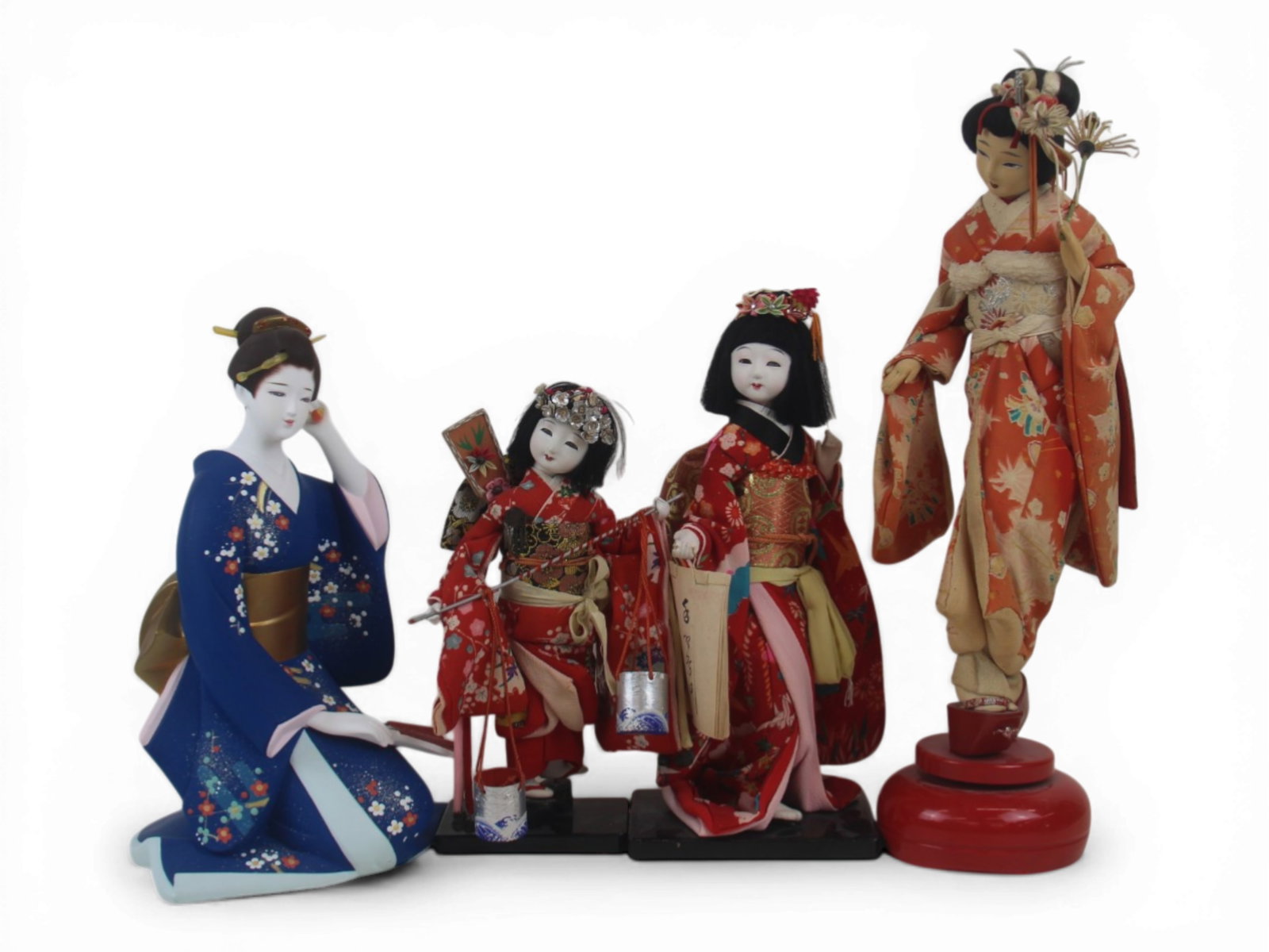 (4) Japanese Souvenir Dolls and Figures: Group of four Japanese souvenir dolls or figures ranging from 16 inches to 9 inches, one being a porcelain figurine, all in original costumes. Late 20th century. Shipping: Weiss Auctions offers