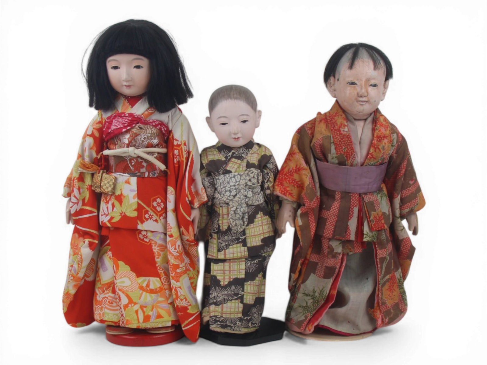 (3) Japanese Gofun Ichimatsu Dolls: Three Japanese Ichimatsu dolls with gofun finish, measuring 19 to 16 inches, in original costumes. One shows wear to the face. Circa 1920s-1960s. Shipping: Weiss Auctions offers full-service, in-house