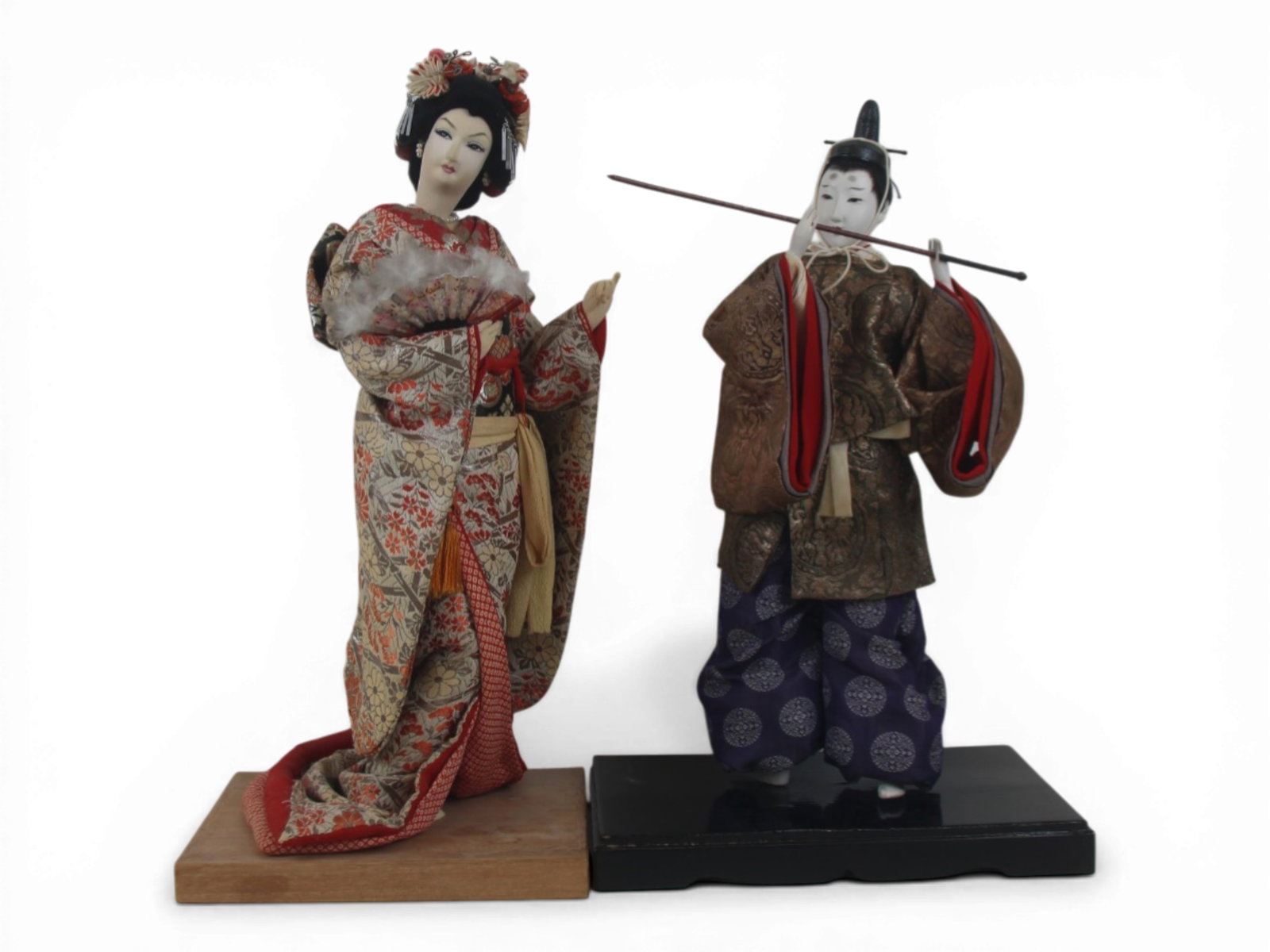 (2) Japanese Dolls on Bases: Pair of Japanese dolls on bases including a 16.5 inch lady doll with cloth head and a 15 inch man doll with gofun head, both in original costumes. Circa 1920-1960. Shipping: Weiss Auctions offers full