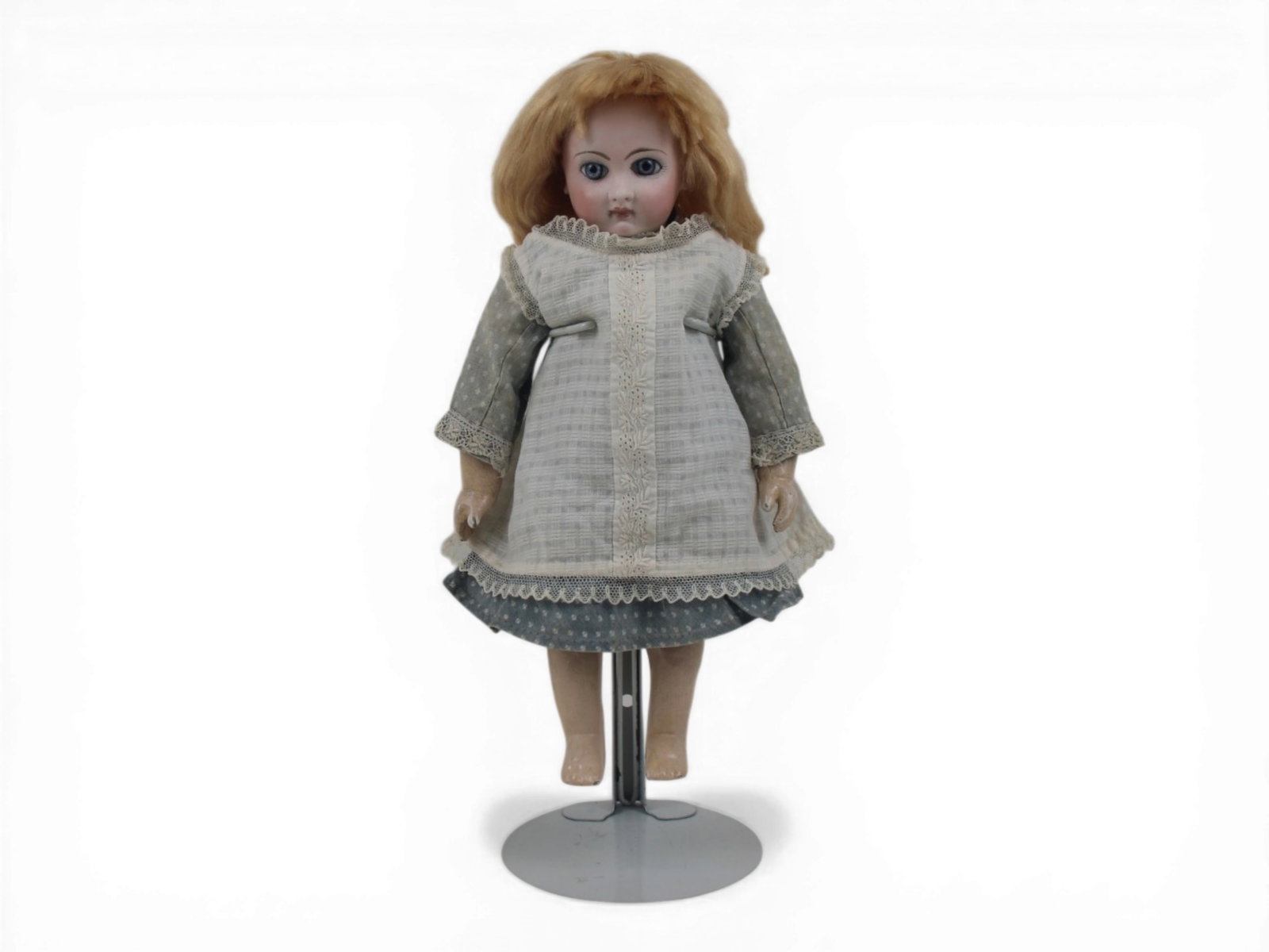 Jumeau EJ2 Closed Mouth Doll: 11.5 inch EJ2 closed mouth Jumeau bisque socket head on fully jointed Jumeau composition and wood body. Restoration to right upper eyelid and brow. Circa 1885. Shipping: Weiss Auctions offers full-ser