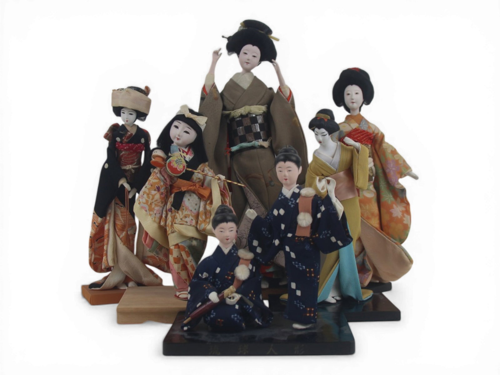 (6) Japanese Souvenir Dolls on Stands: Group of six Japanese dolls ranging from 12 to 6 inches with gofun and cloth bodies in original costumes. Circa 1940s. Shipping: Weiss Auctions offers full-service, in-house shipping for nearly all it