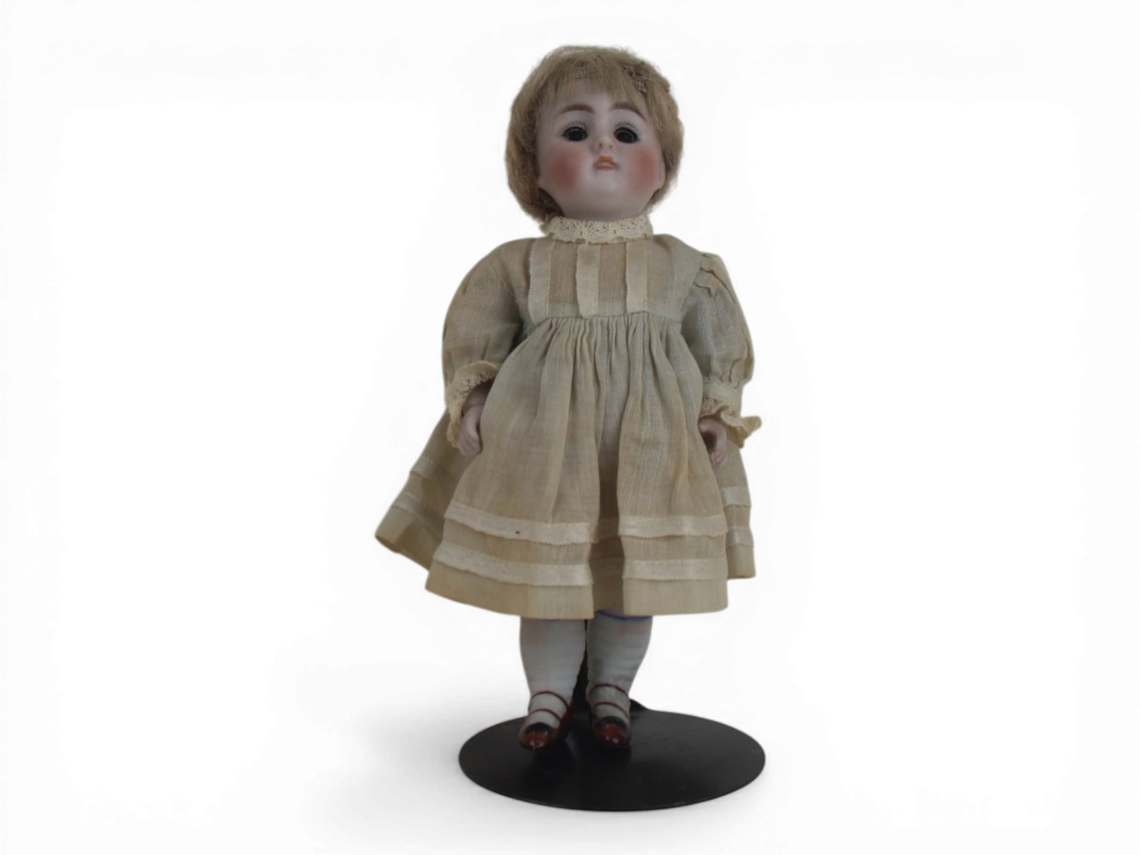 German All Bisque Doll in Antique Dress: 6.5 inch German all bisque doll jointed at shoulders and hips with antique dress and original wig. Circa 1900. Shipping: Weiss Auctions offers full-service, in-house shipping for nearly all items in t