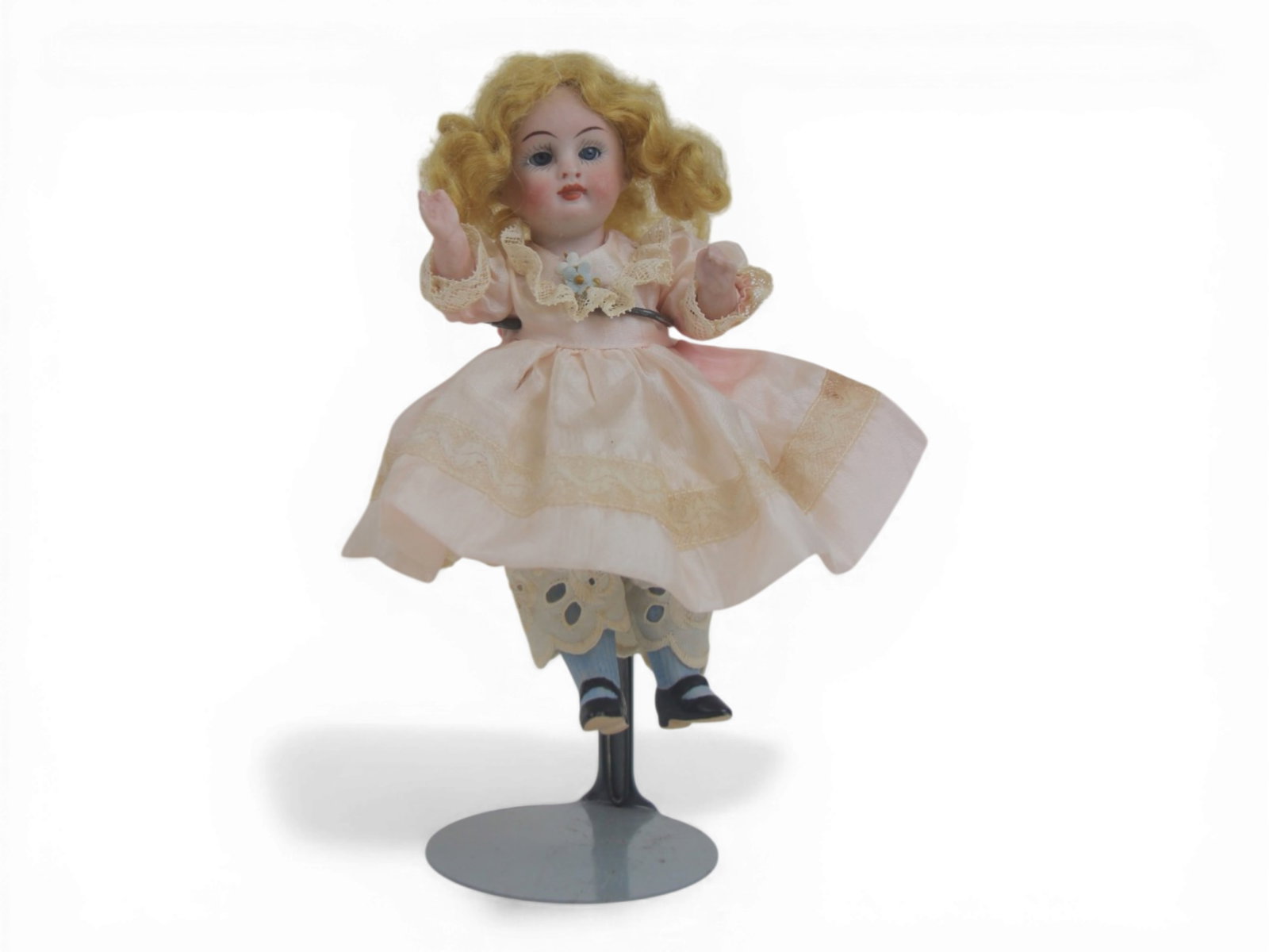 German All Bisque Doll in Antique Dress: 7 inch German all bisque doll with jointed arms and legs, antique dress, and painted shoes and socks. Circa 1900. Shipping: Weiss Auctions offers full-service, in-house shipping for nearly all items i
