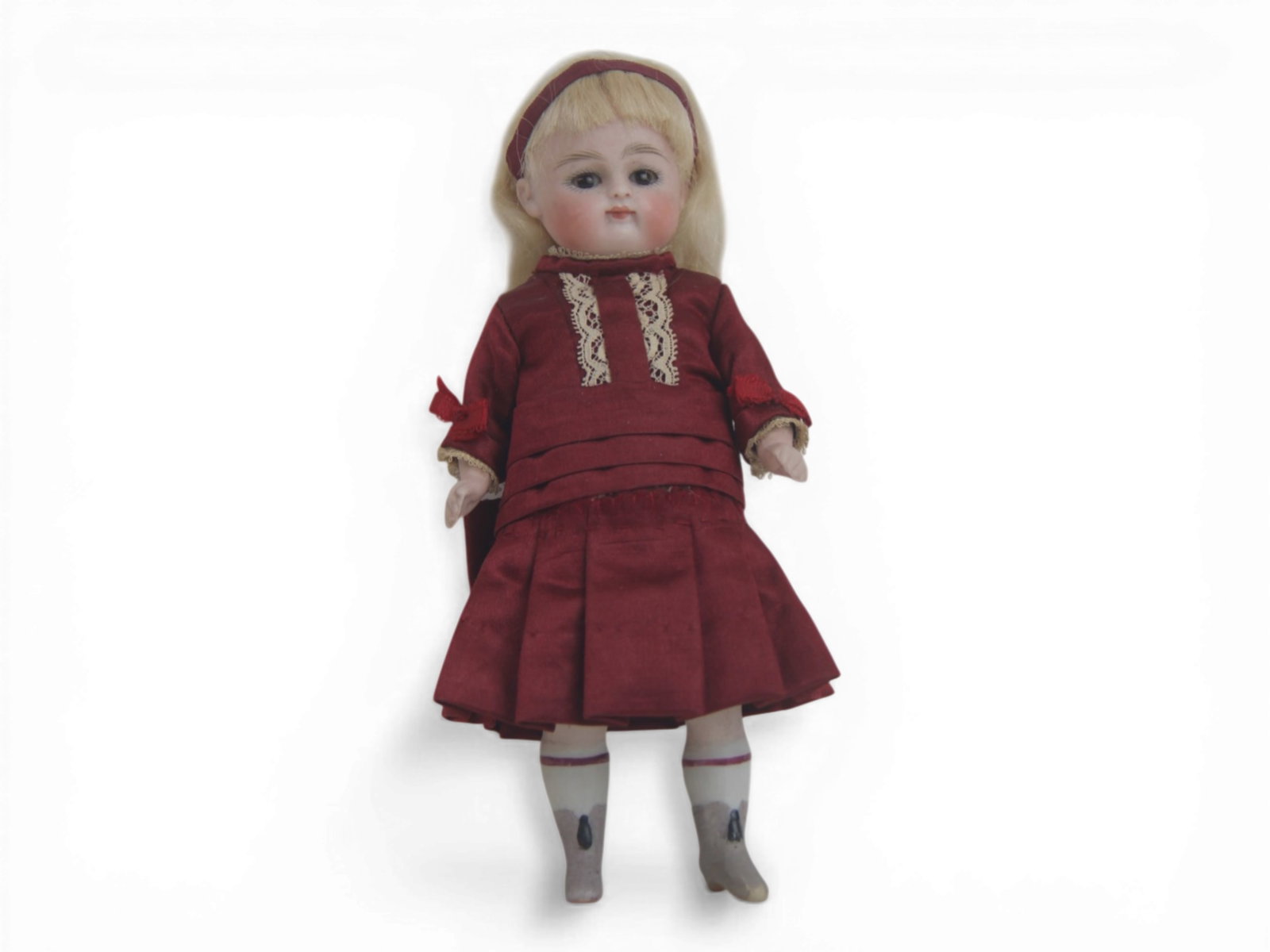 German All Bisque Doll (Attrib. Kestner): 6.5 inch bisque socket head doll with jointed arms and legs, closed mouth, sleep eyes, painted boots with tassels, original wig and dress. Attributed to Kestner. Circa 1900. Shipping: Weiss Auctions o