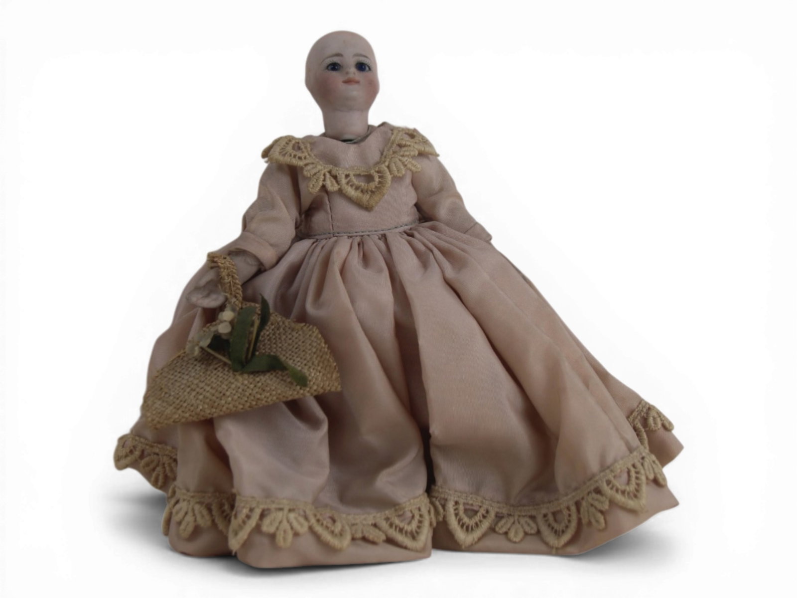 All Bisque Mignonette Doll: 7 inch all bisque mignonette doll jointed at neck, shoulders, and hips with painted double strap shoes and stockings. Antique dress. Circa 1900. Shipping: Weiss Auctions offers full-service, in-house