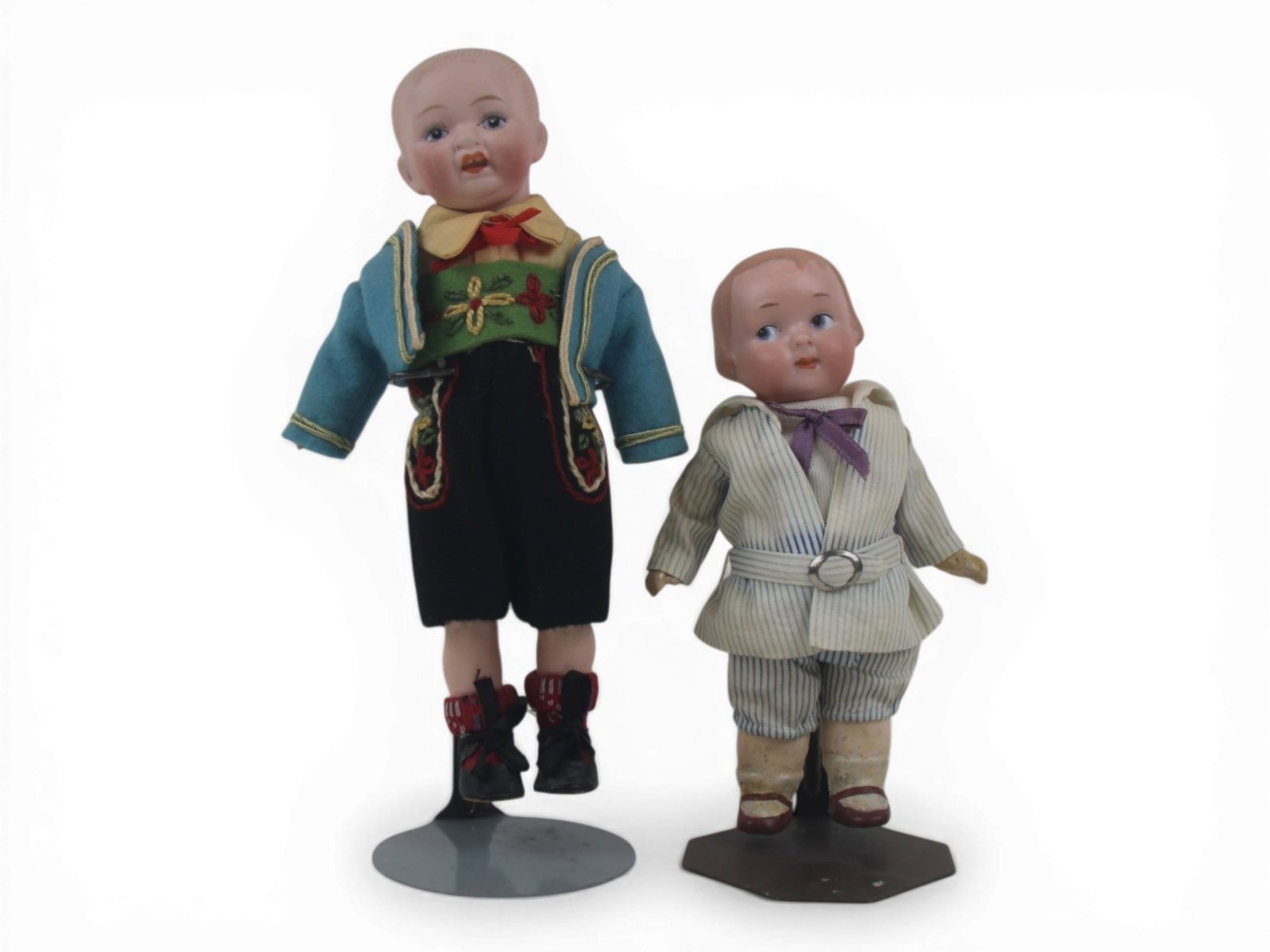 (2) German Bisque Head Dolls: Two German bisque head dolls including a 7 inch Armand Marseille 210 googly and an 8 inch character boy doll, both on composition bodies with costumes. Circa 1920. Shipping: Weiss Auctions offers full