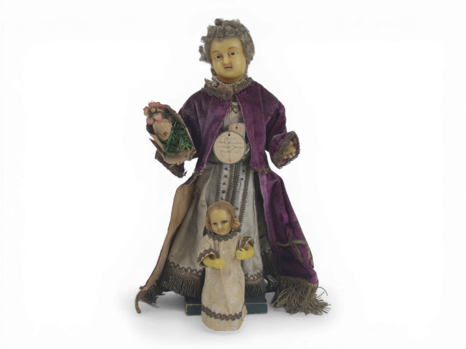 (2) French Poured Wax Catholic Dolls: 13 inch wax lady doll with glass eyes and elaborate costume plus a 5.5 inch Infant of Prague wax doll with glass eyes and original costume. Circa 1780-1800. Shipping: Weiss Auctions offers full-servic
