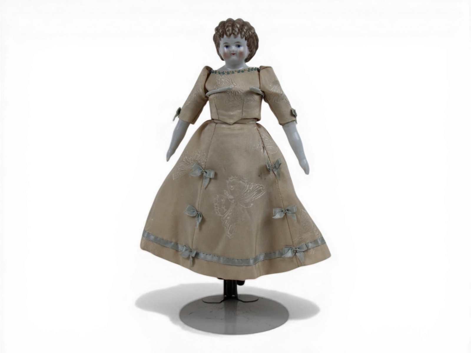 German Curly Top China Head Doll: 10.5 inch curly top china head doll on cloth body with china limbs. Circa 1875. Shipping: Weiss Auctions offers full-service, in-house shipping for nearly all items in this auction. For a shipping quo