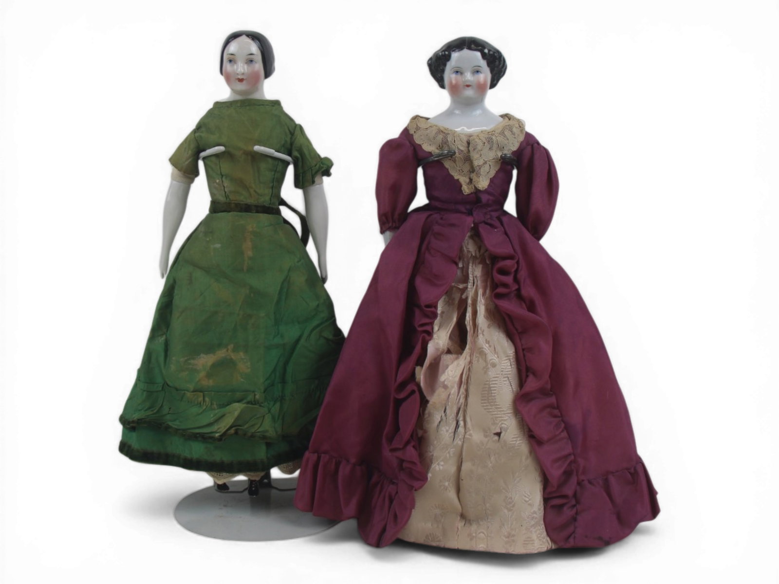 (2) German China Head Dolls: Two German china head dolls including KPM type head example and highbrow style example with antique clothing. Circa 1850-1900. Shipping: Weiss Auctions offers full-service, in-house shipping for nearl