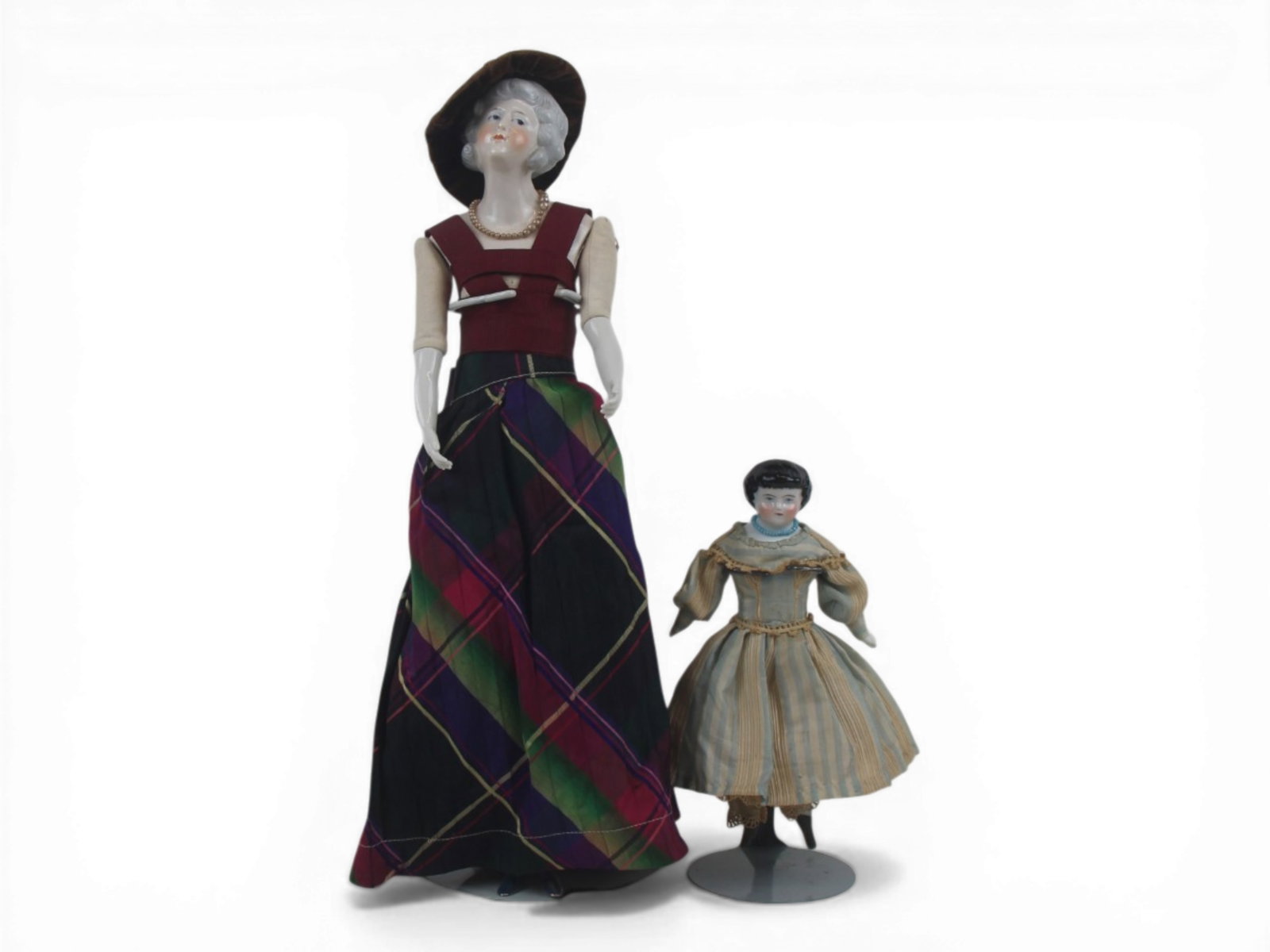 (2) German China Head Dolls: Two German china head dolls measuring 14.5 and 7 inches on cloth bodies with china limbs. Circa 1880-1920. Shipping: Weiss Auctions offers full-service, in-house shipping for nearly all items in this 