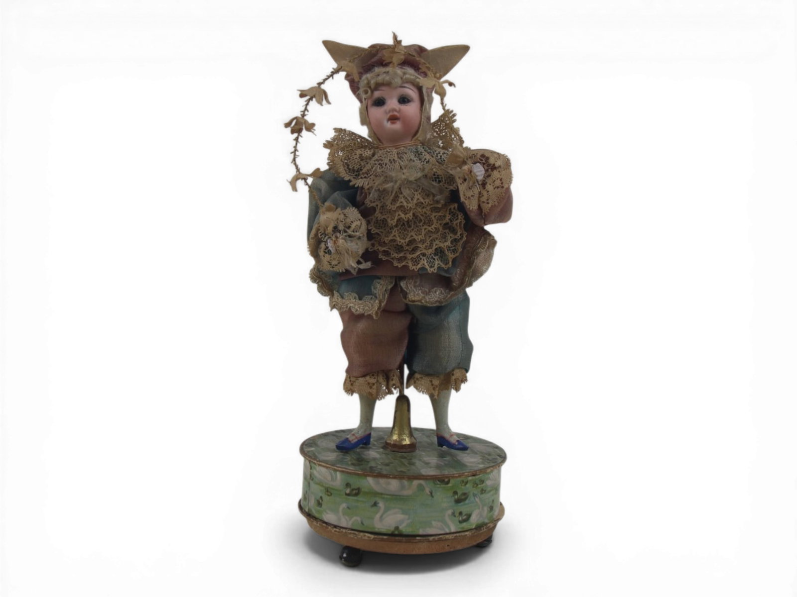 Bisque Head Doll on Music Box: 8 inch bisque head doll with bisque hands on wired armature mounted on working music box in jester costume. Circa 1890. Shipping: Weiss Auctions offers full-service, in-house shipping for nearly all i