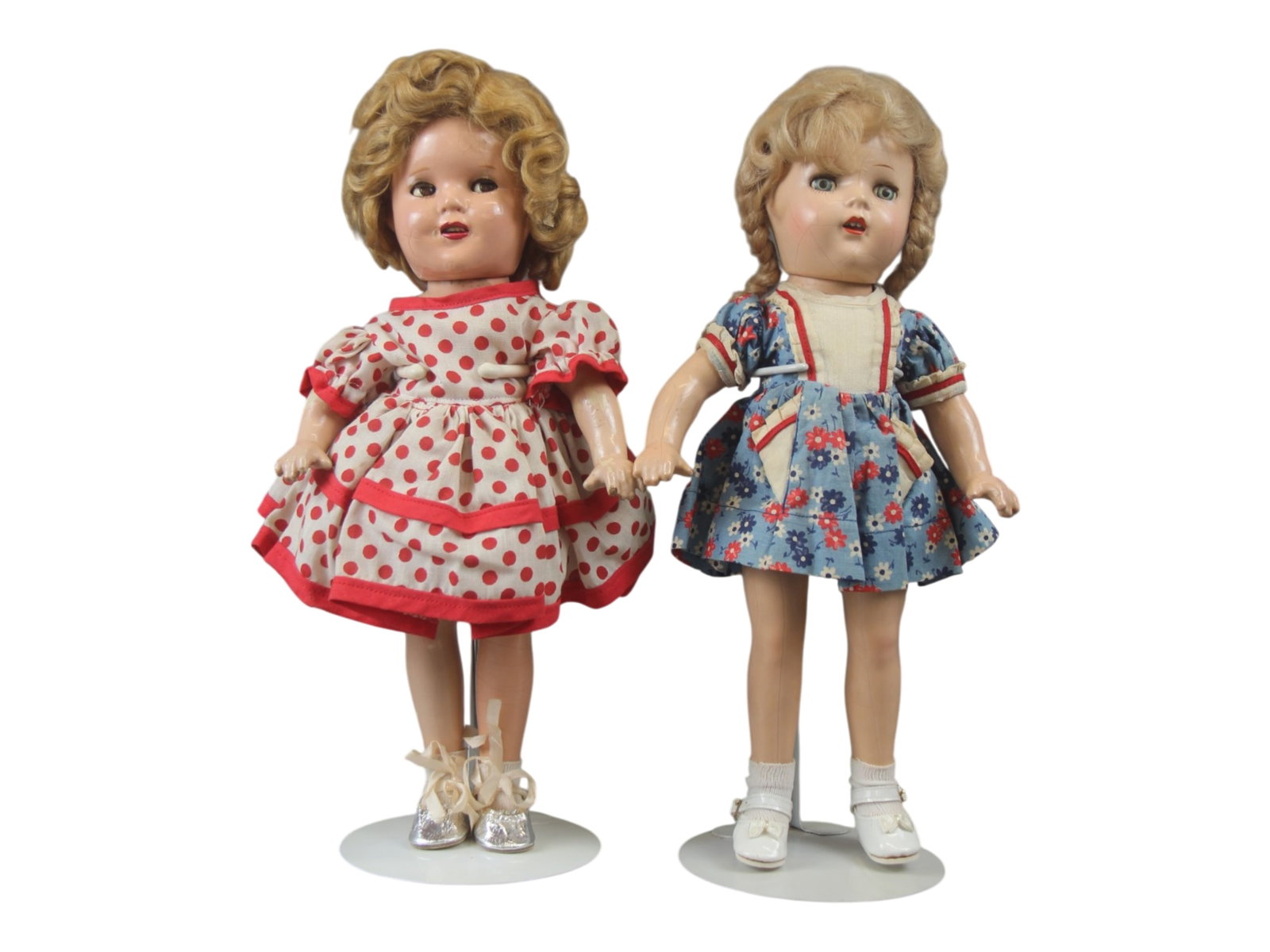 (2) Shirley Temple & Composition Dolls: 13 inch Shirley Temple doll, marked on back, with flirty eyes and Shirley Temple style dress, plus a 12 inch unmarked composition doll. Both have mohair wigs. Circa 1930s-1940s. Shipping: Weiss Auctio