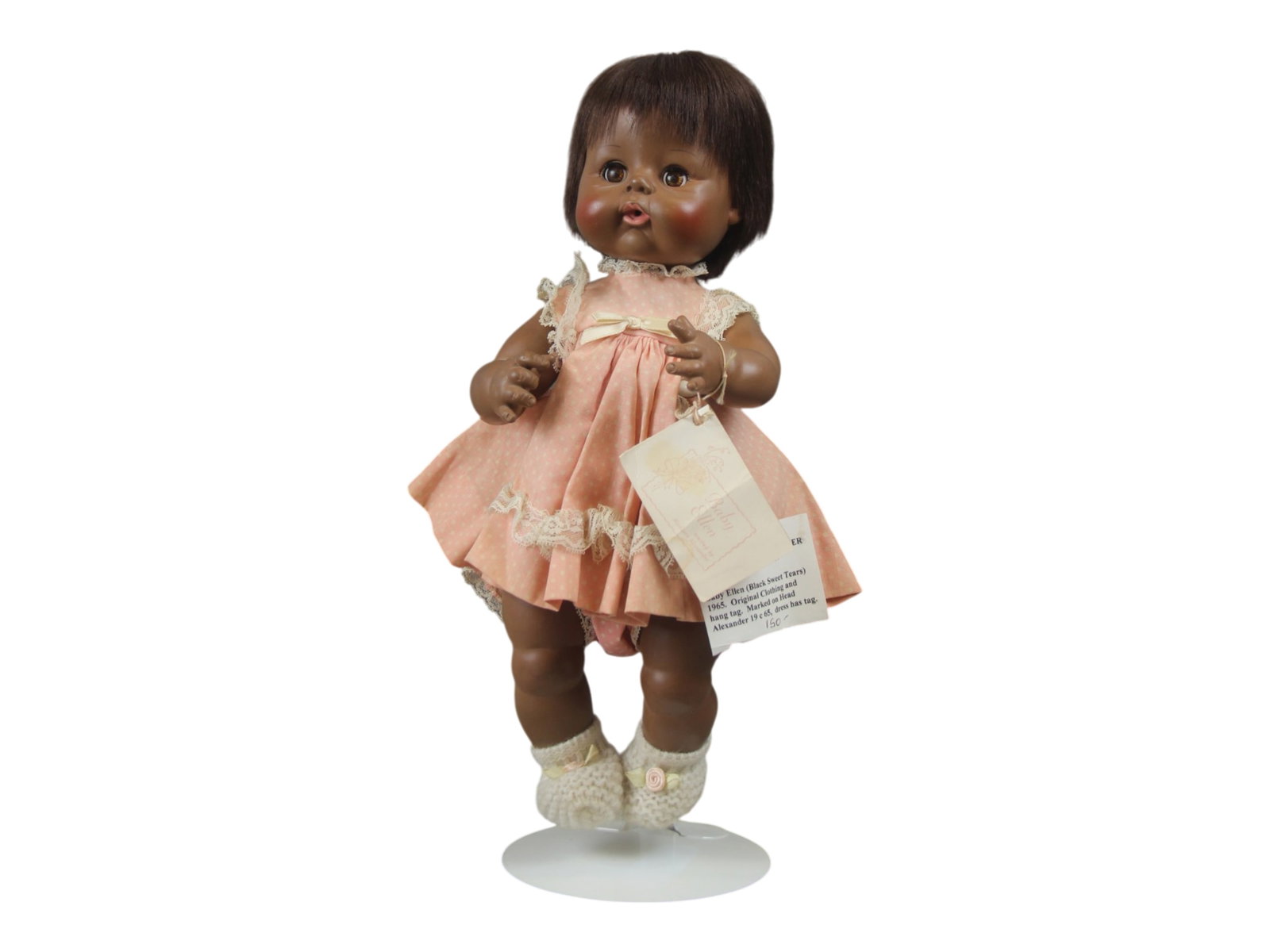 Madame Alexander Baby Ellen Doll: 13 inch vinyl doll in original clothes with tag. Circa 1965. Shipping: Weiss Auctions offers full-service, in-house shipping for nearly all items in this auction. For a shipping quote, please contact 