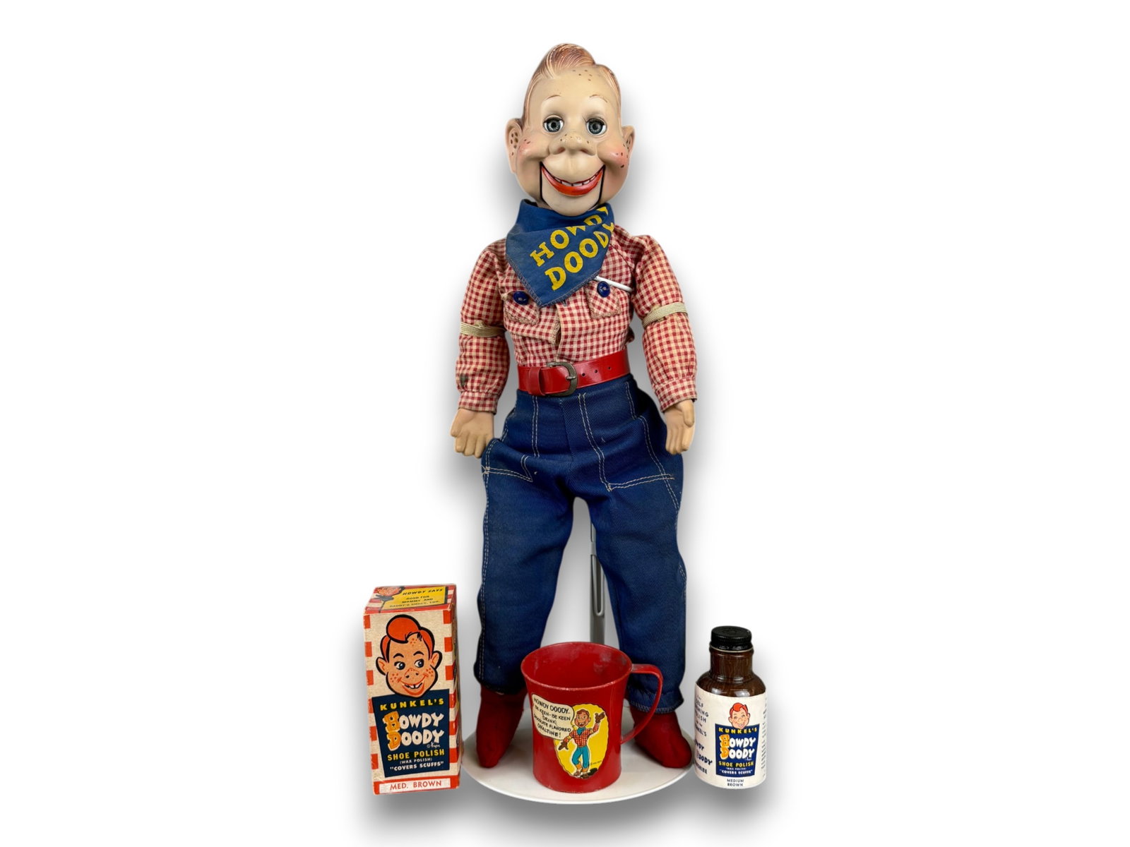 (3) Howdy Doody Puppet & Accessories: 21 inch Howdy Doody puppet in original clothes together with Kunkel's shoe polish in box and a plastic cup. Circa 1950s. Shipping: Weiss Auctions offers full-service, in-house shipping for nearly all 