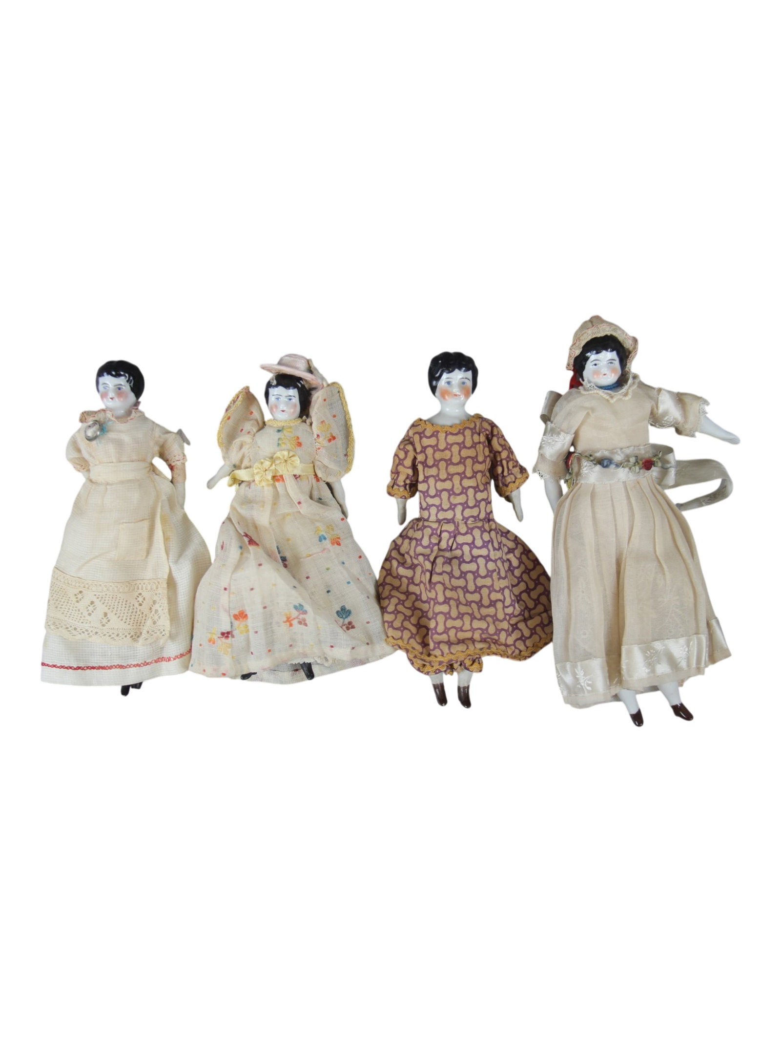 (4) Antique China Head Dolls: Four china head dolls measuring 6.5 to 7.5 inches with china limbs and cloth bodies. One has a broken foot and hand. Circa 1880s. Shipping: Weiss Auctions offers full-service, in-house shipping for