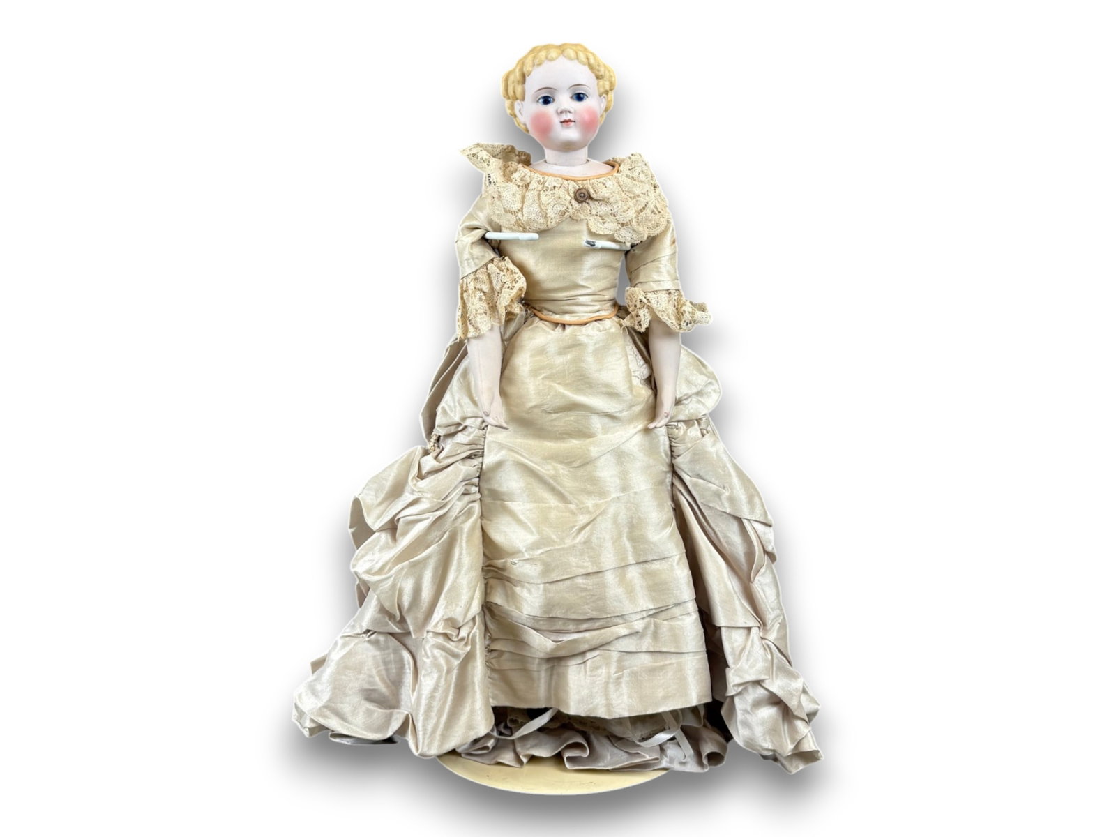 German Tinted Bisque Head Doll: 19 inch tinted bisque socket head on bisque shoulder plate and cloth body with bisque lower arms and legs. Molded painted hair, closed mouth, and antique silk dress. Circa 1870s. Shipping: Weiss