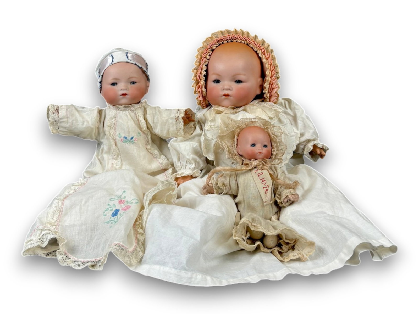 (3) Antique German Baby Dolls: Two Armand Marseille dolls, a 12 inch Dream Baby and a 17 inch #341 Dream Baby, together with an 8 inch H. Steiner My Playmate. All with bisque flange heads on cloth bodies. Circa 1920s. Shipping: Wei