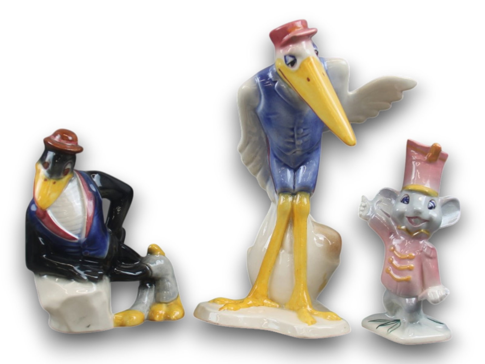 A Collection of Vernon Kilns Figurines from Dumbo.: (Vernon Kilns, 1941) A fantastic collection of three figurines from Disney's "Dumbo" produced by Vernon Kilns in the 1940s. Included are an scarce Messenger Stork standing almost 9" tall, a Jim Dandy 