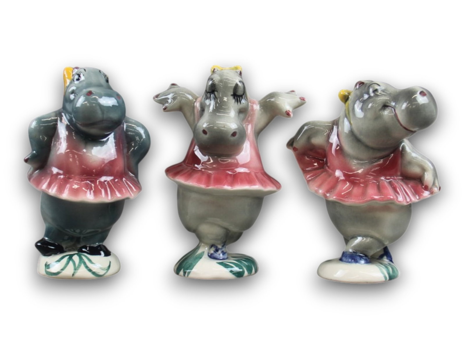 Three Vernon Kilns Fantasia Hippo Figurines.: (Vernon Kilns, 1940) Three painted glazed ceramic hippo ballerina figurines from the Dance of the Hours segment of "Fantasia." Measuring 5"high and 3.5" to 4.5" wide, the figures are in very fine cond