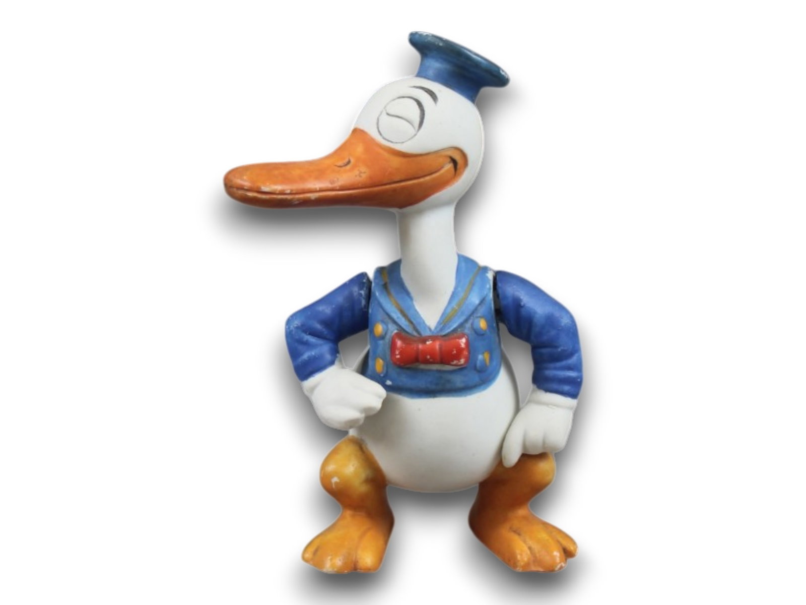 Disney. Bisque Long Billed Donald Duck: 6" tall w/movable arms. Made in Japan as noted by incised "Made In Japan" text on back and stamped "Japan" text on underside of one foot. 1930s. Shipping: Weiss Auctions offers full-service, in-house 